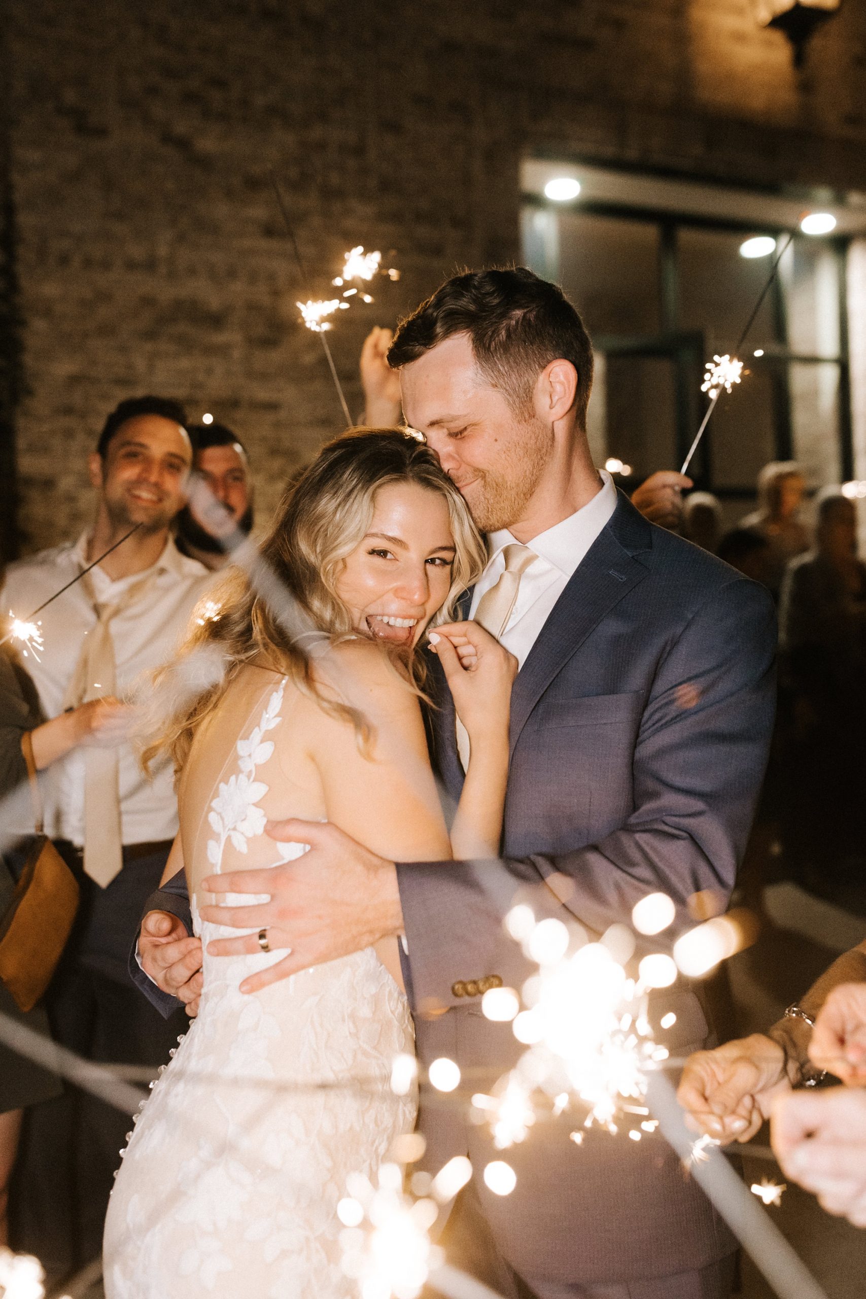 newlyweds hug during sparkler exit outside Wrightsville Manor 