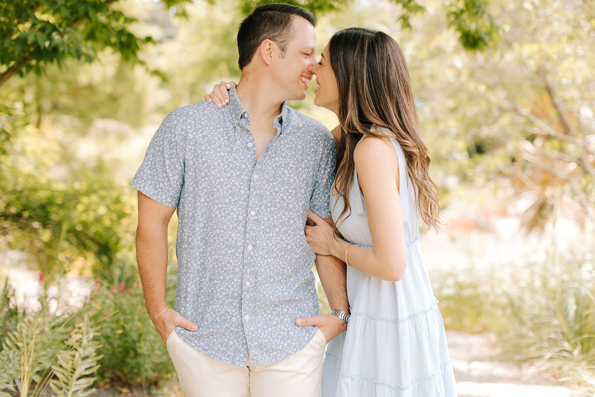 bride and groom laugh touching noses during Raleigh NC engagement session