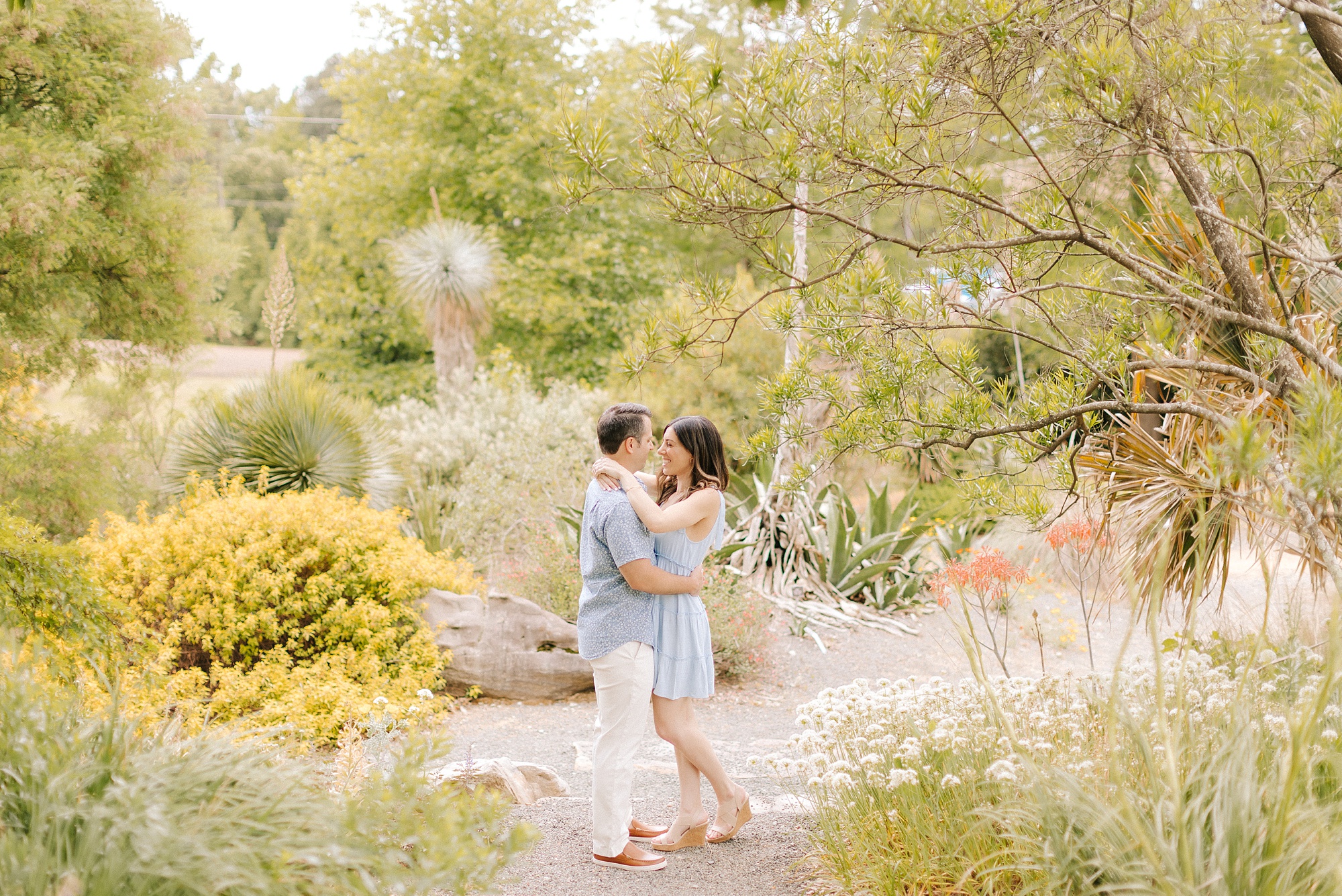 engaged couple hugs in JC Raulston Arboretum