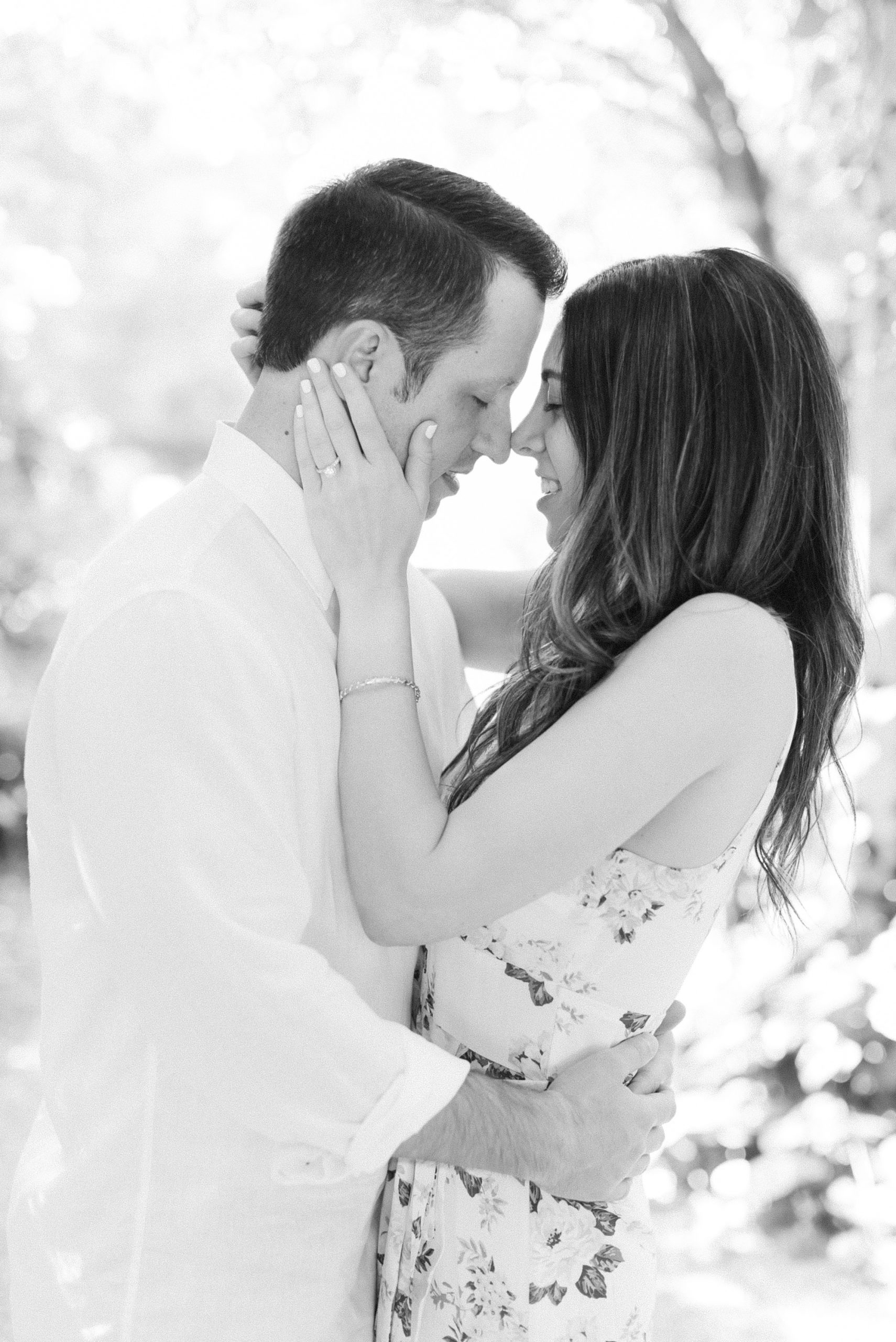 bride and groom stand nose to nose during NC engagement session
