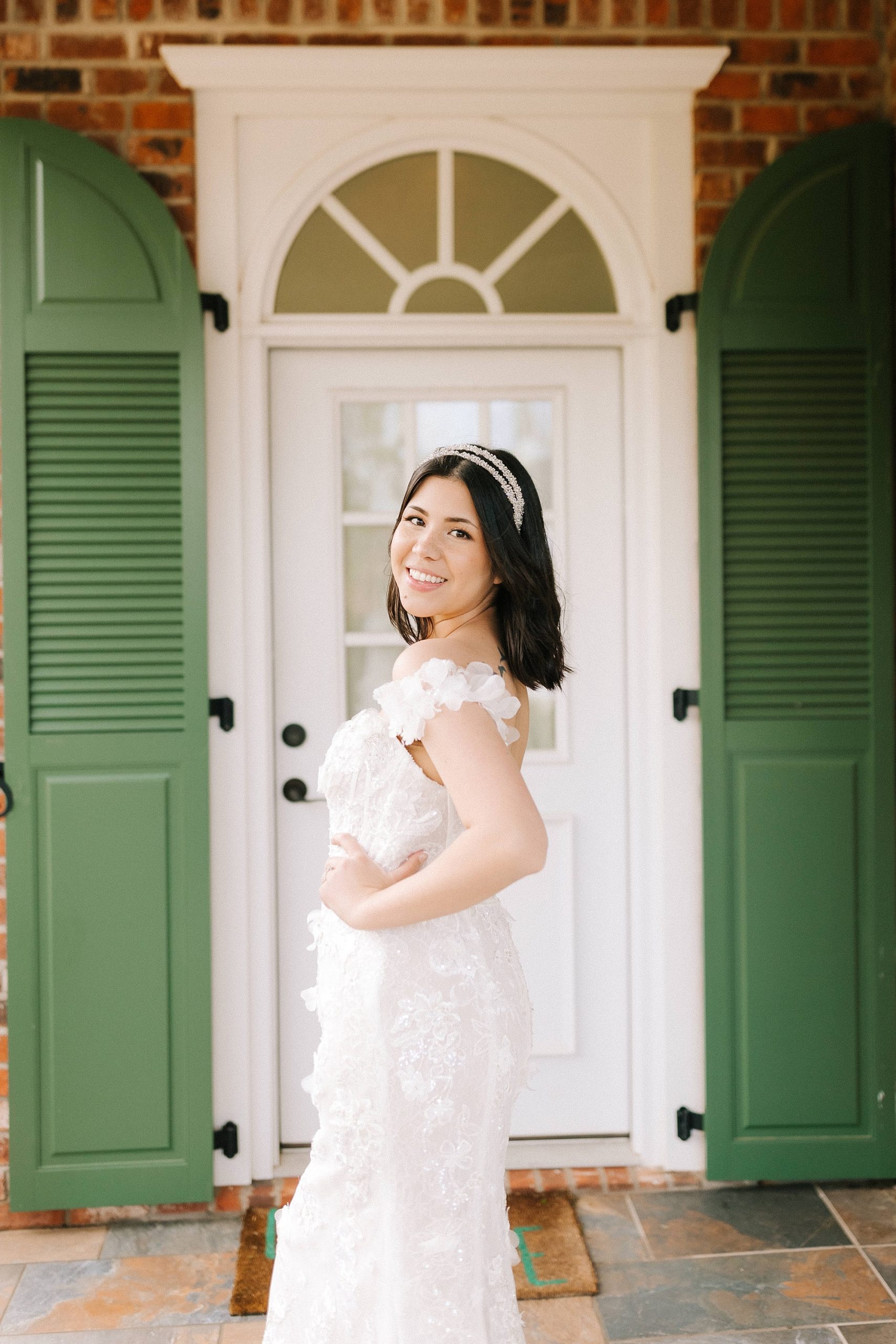 bride puts hand on hip looking over shoulder during portraits 