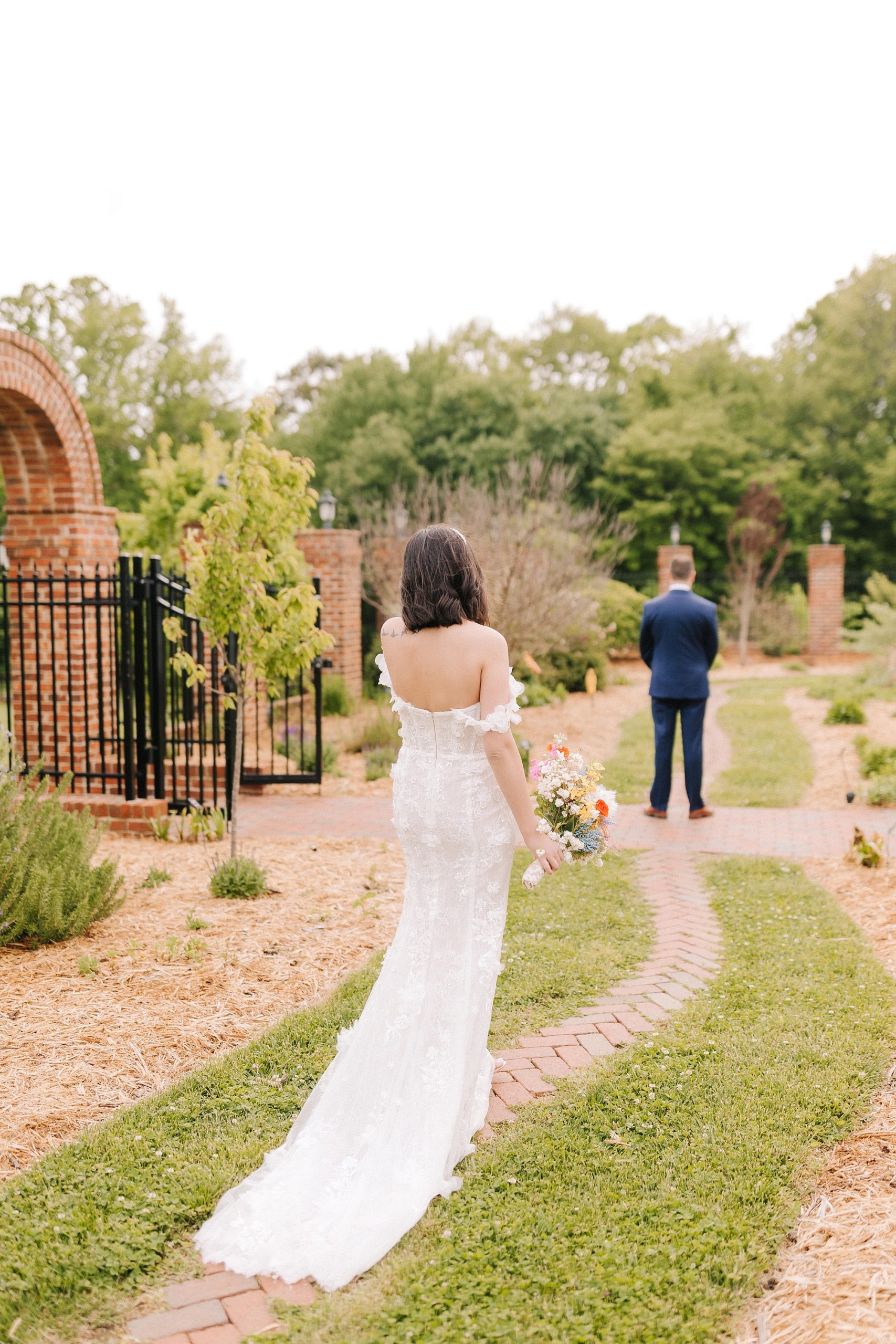 bride walks to meet groom before first look 