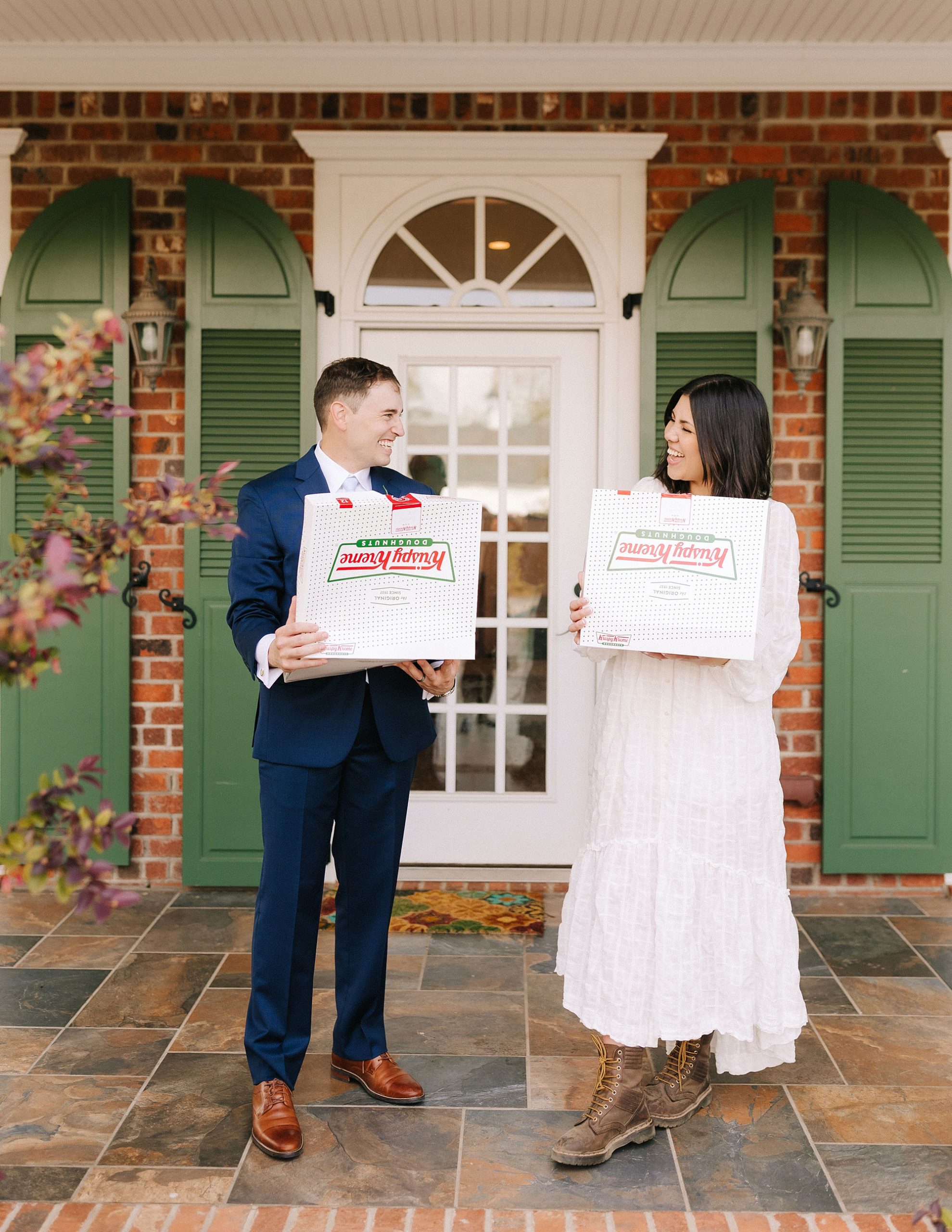 bride and groom hold boxes of Krispy Kreme donuts