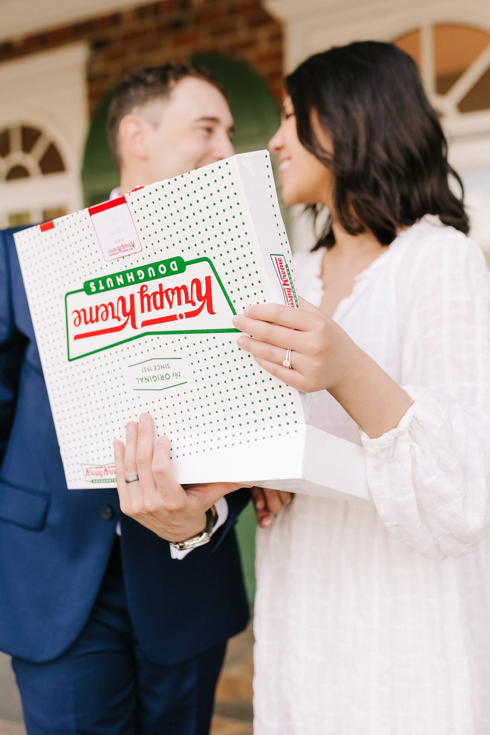 bride lifts lid of Krispy Kreme donut box