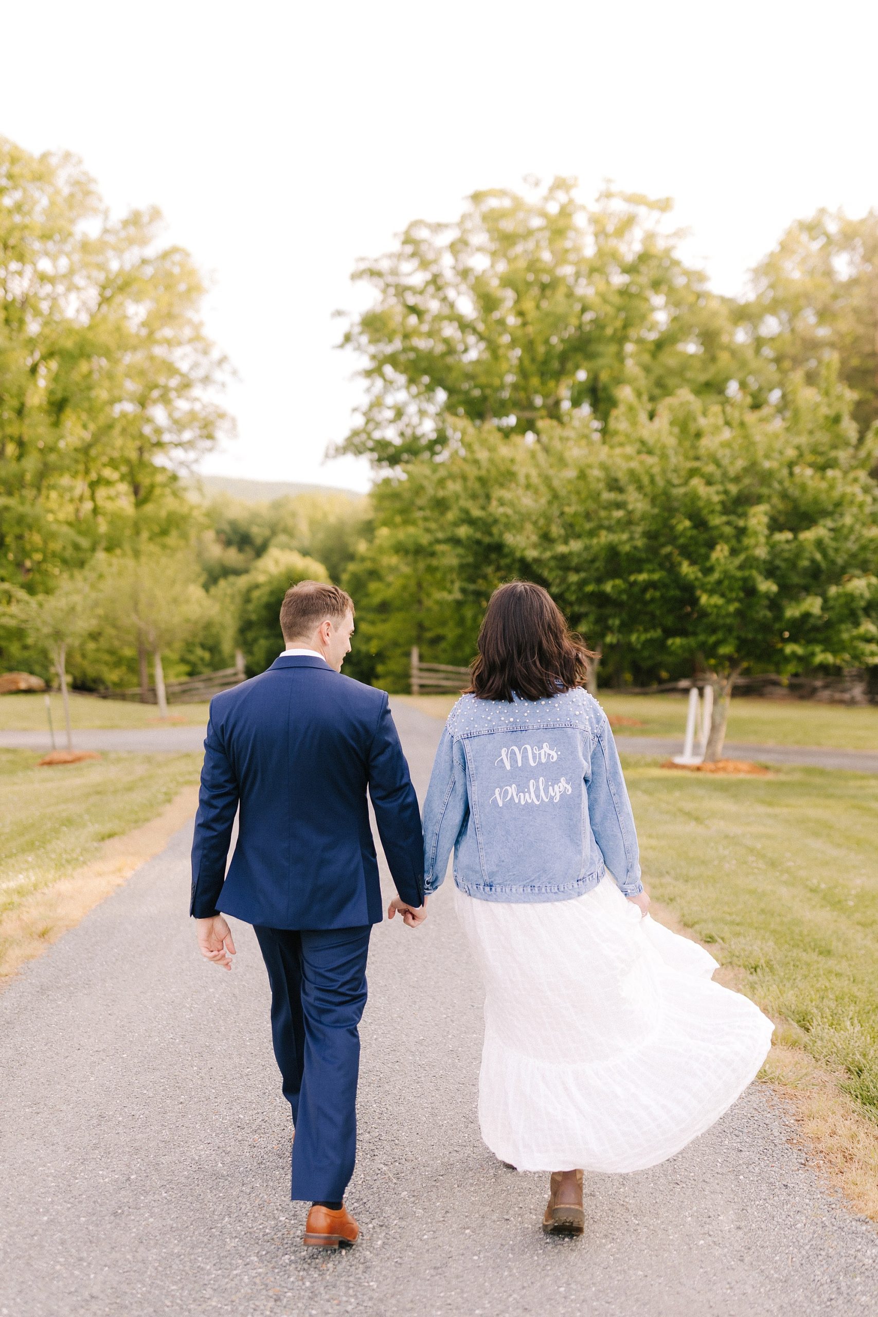 bride and groom walk down path after Moore's Spring Manor elopement