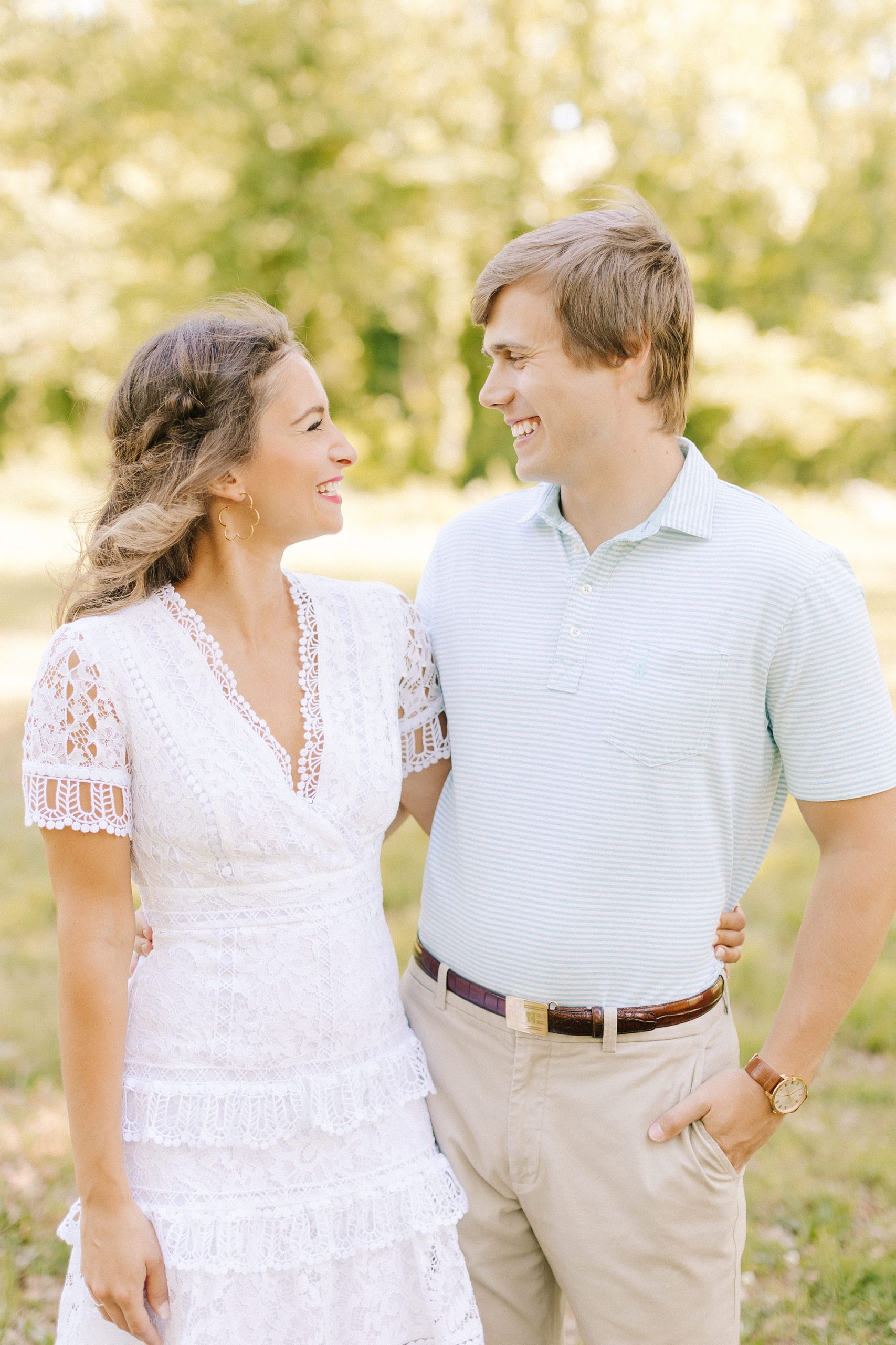bride and groom look at each other during spring engagement photos at Reynolda Gardens