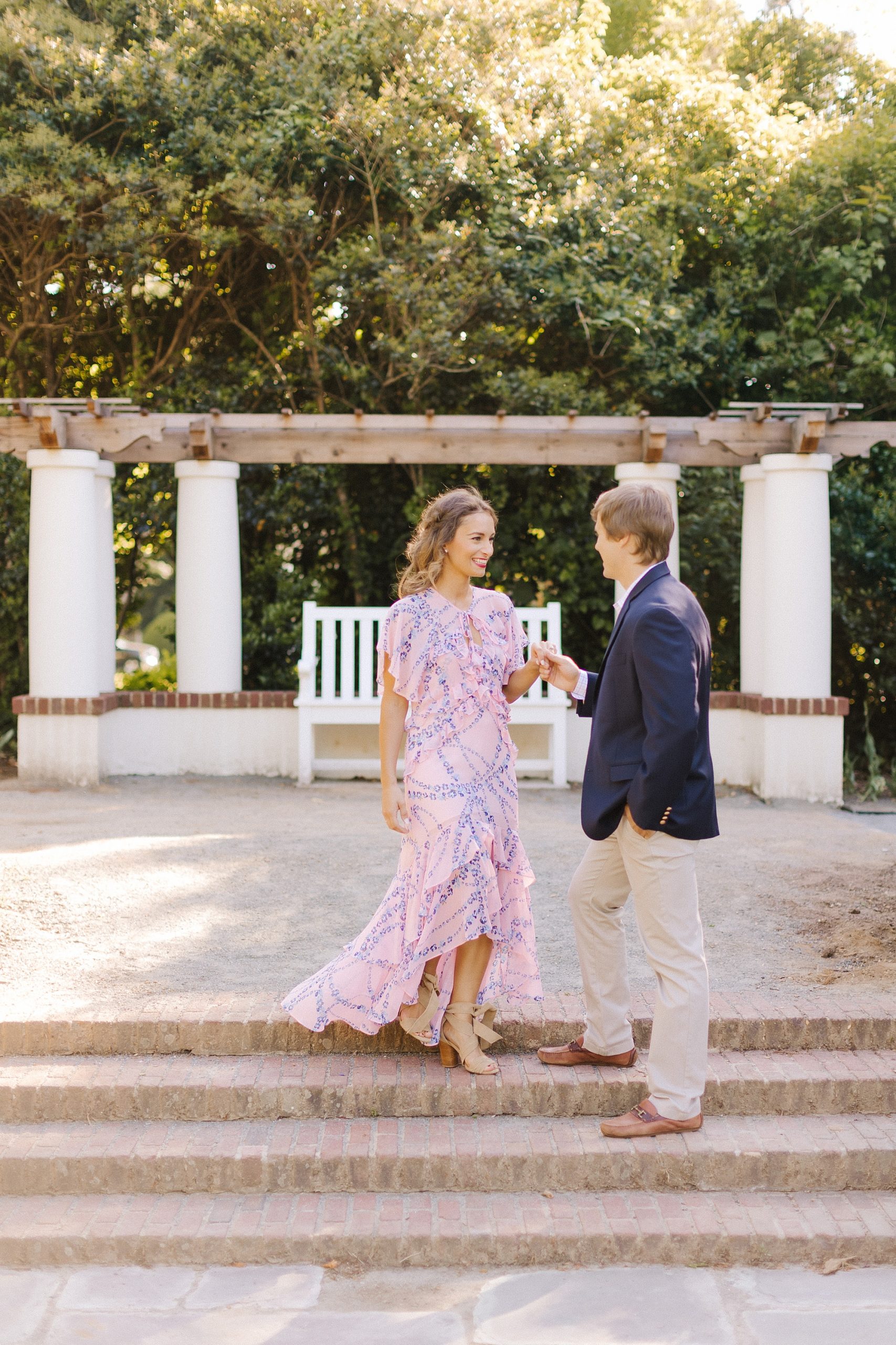 groom help bride down steps at Reynolda Gardens