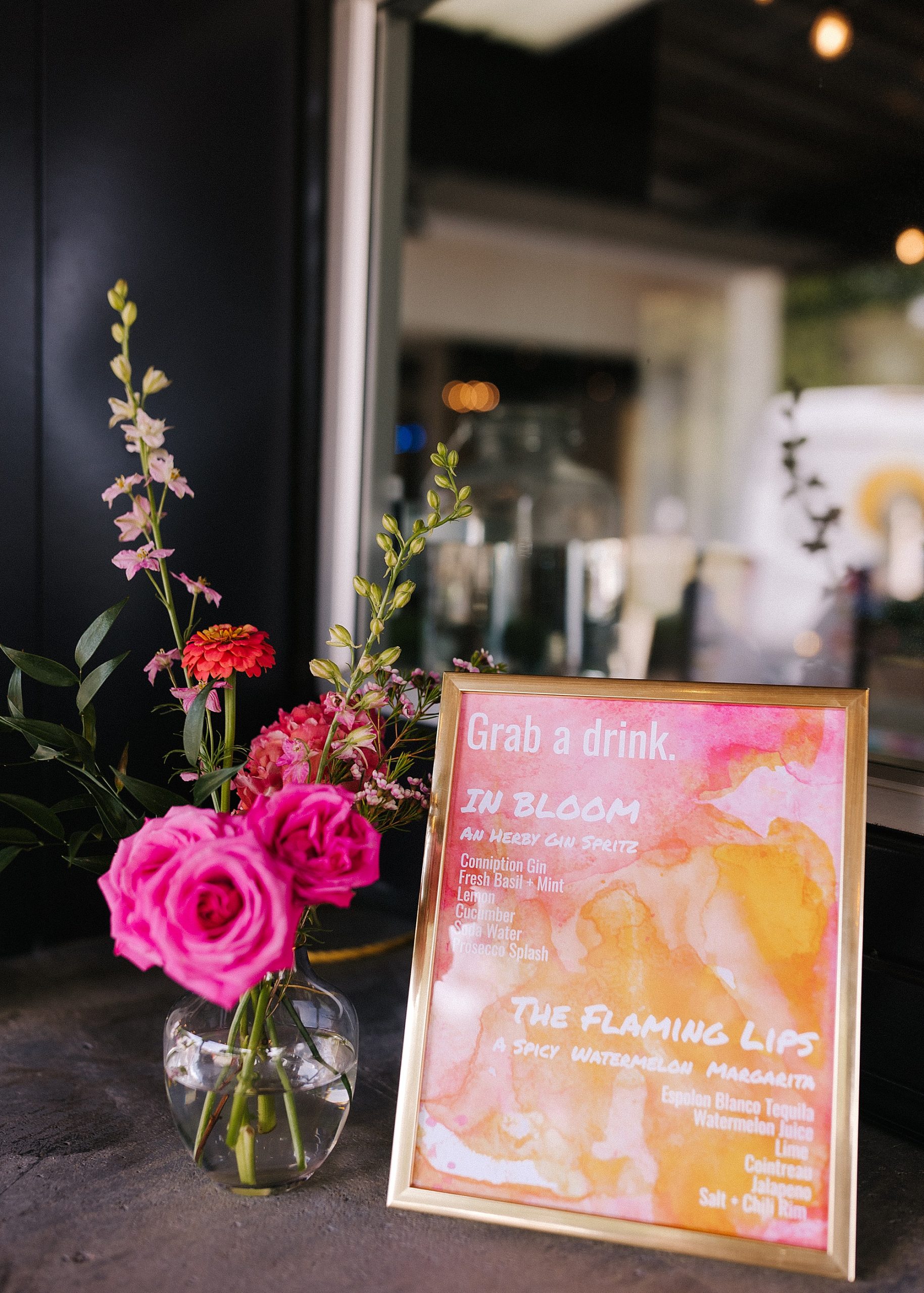 signature drink sign with pink and orange colors