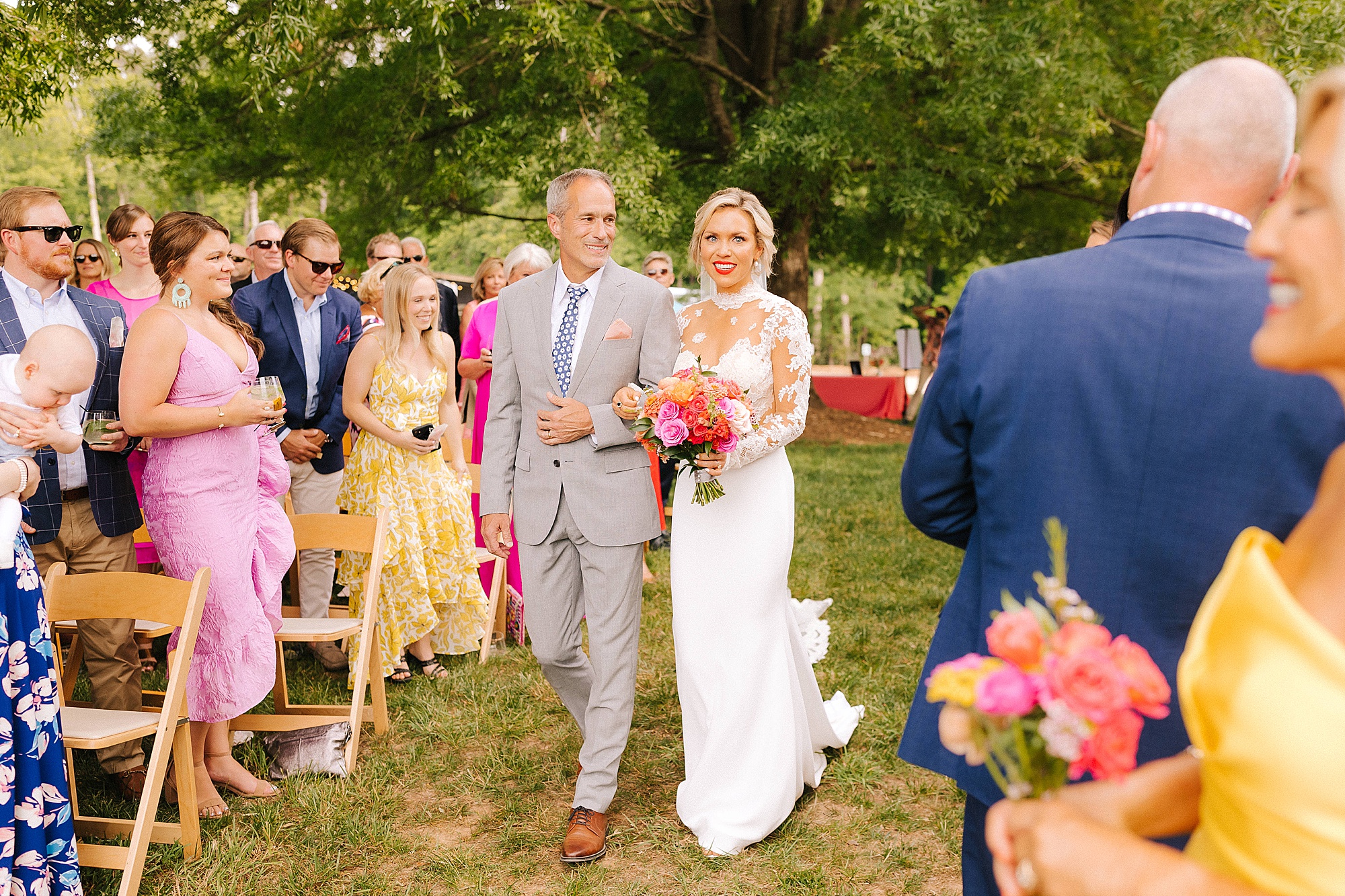 bride walks down the aisle with dad at The Meadows Raleigh