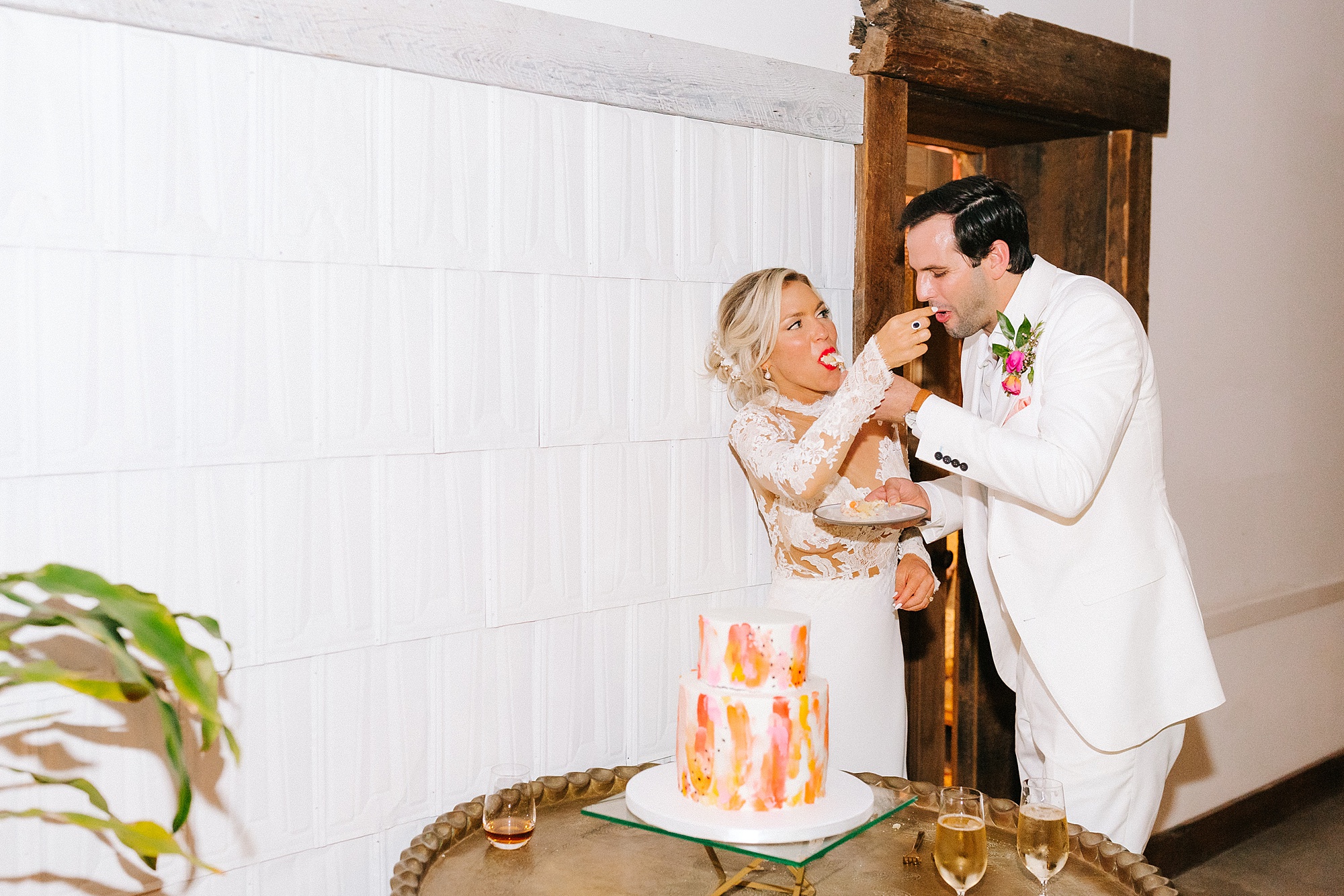 bride and groom feed each other cake during Raleigh NC wedding reception