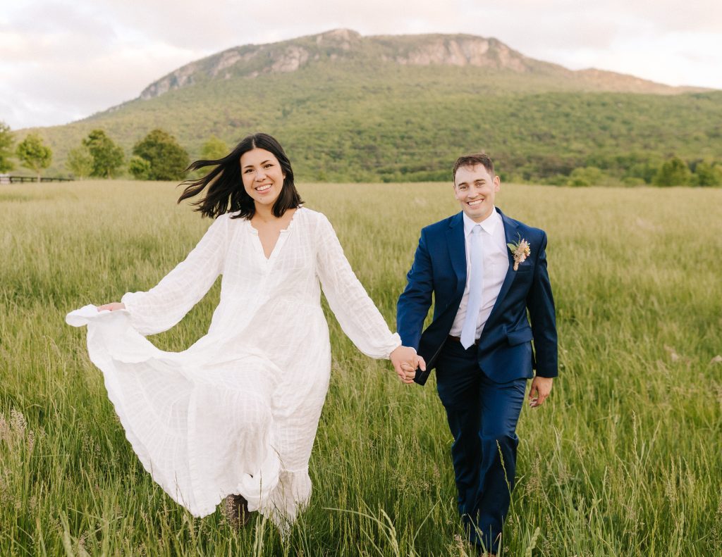 couple runs through a field at their North Carolina Elopement