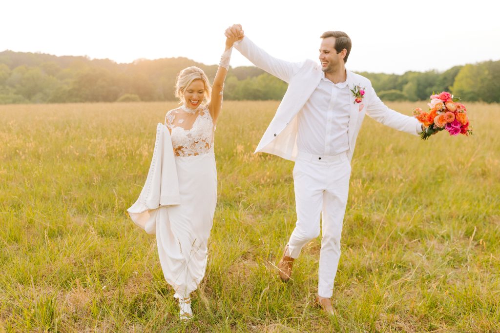 bride and groom walk on path at sunset at The Meadows Raleigh