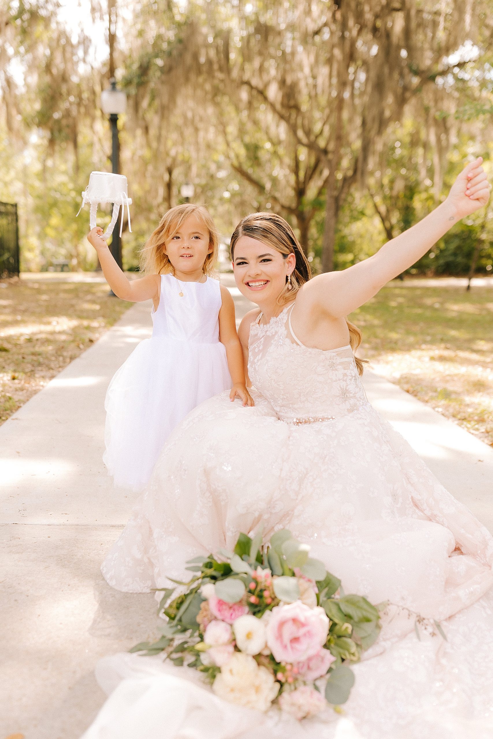 bride and flower girl cheer during photos in Gainesville FL