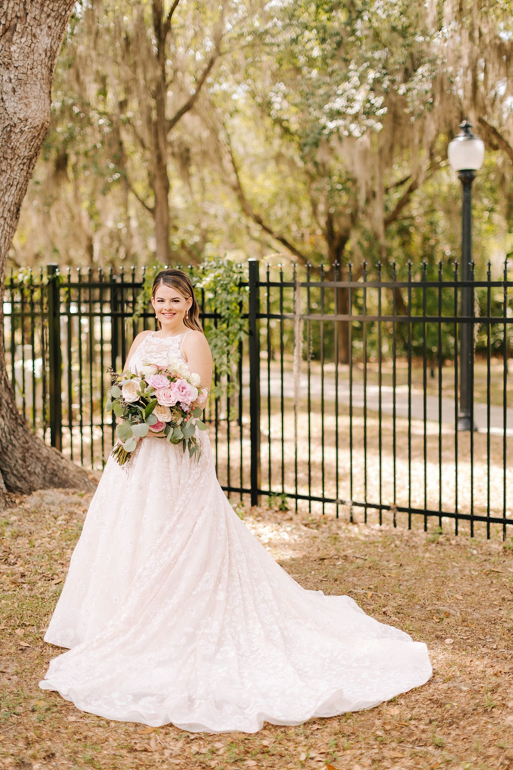 bride holds bouquet of pink flowers in Gainesville FL