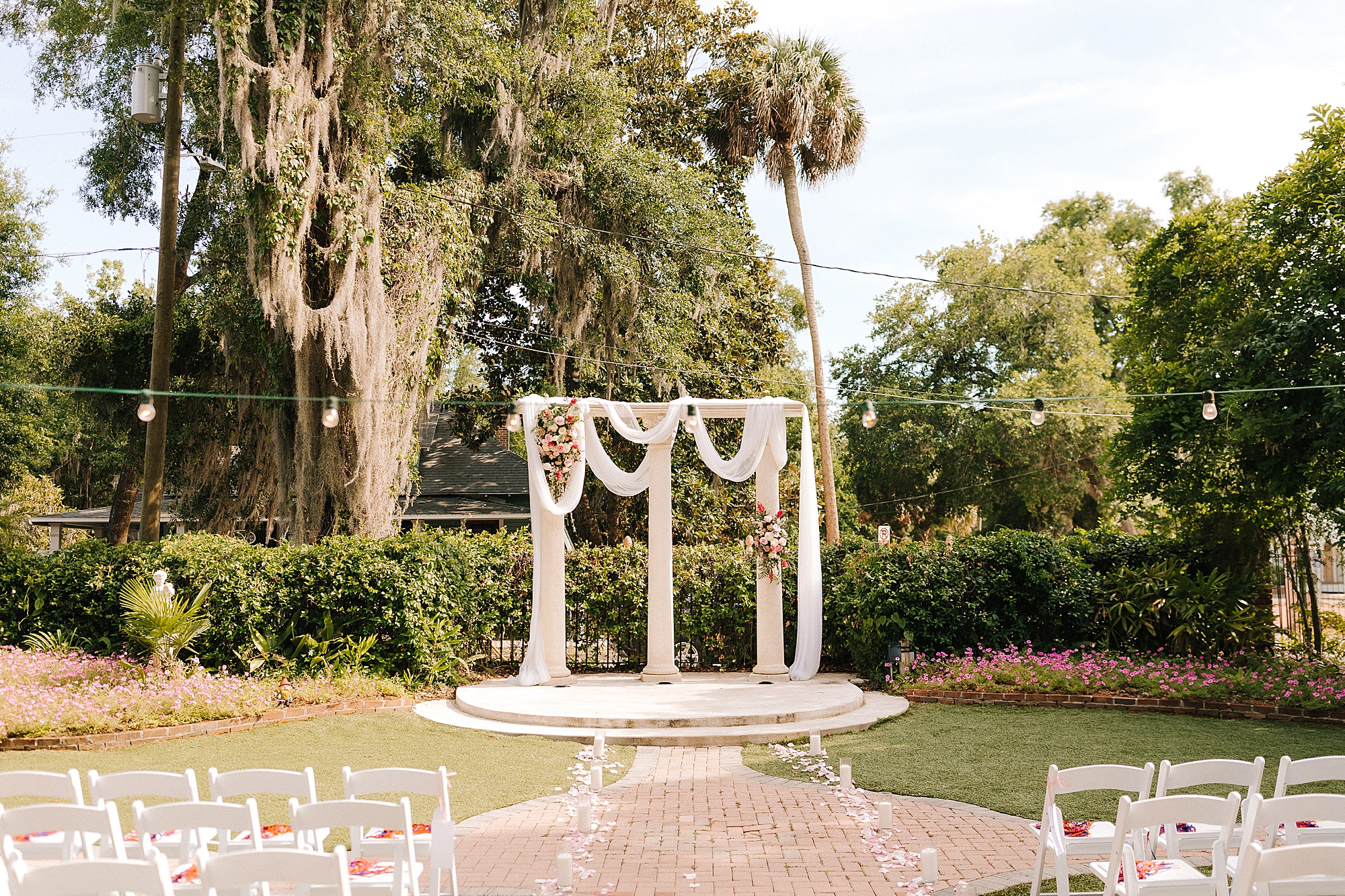arbor with draped white cloth for outdoor wedding ceremony in Florida