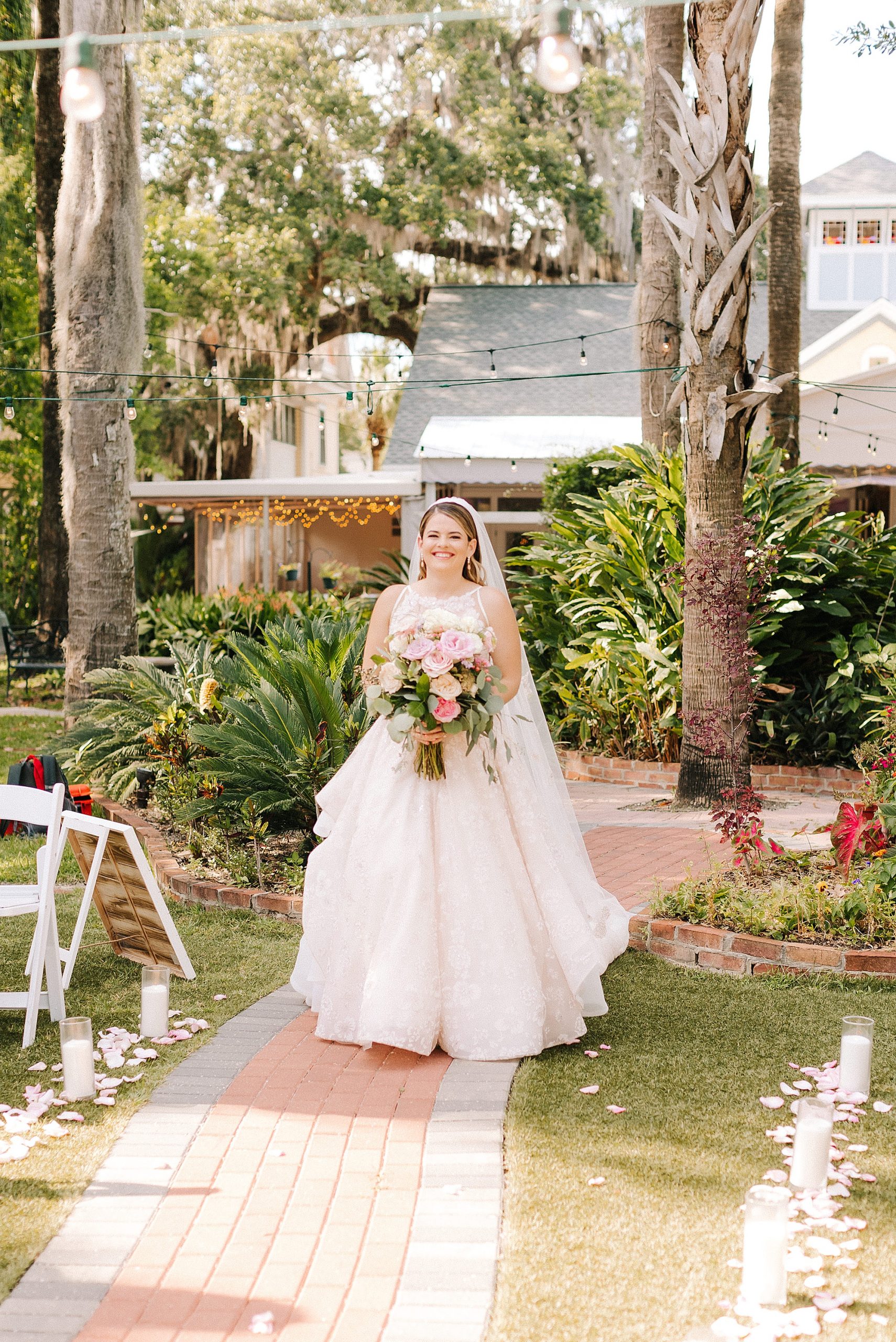bride walks down aisle for outdoor wedding ceremony in Florida