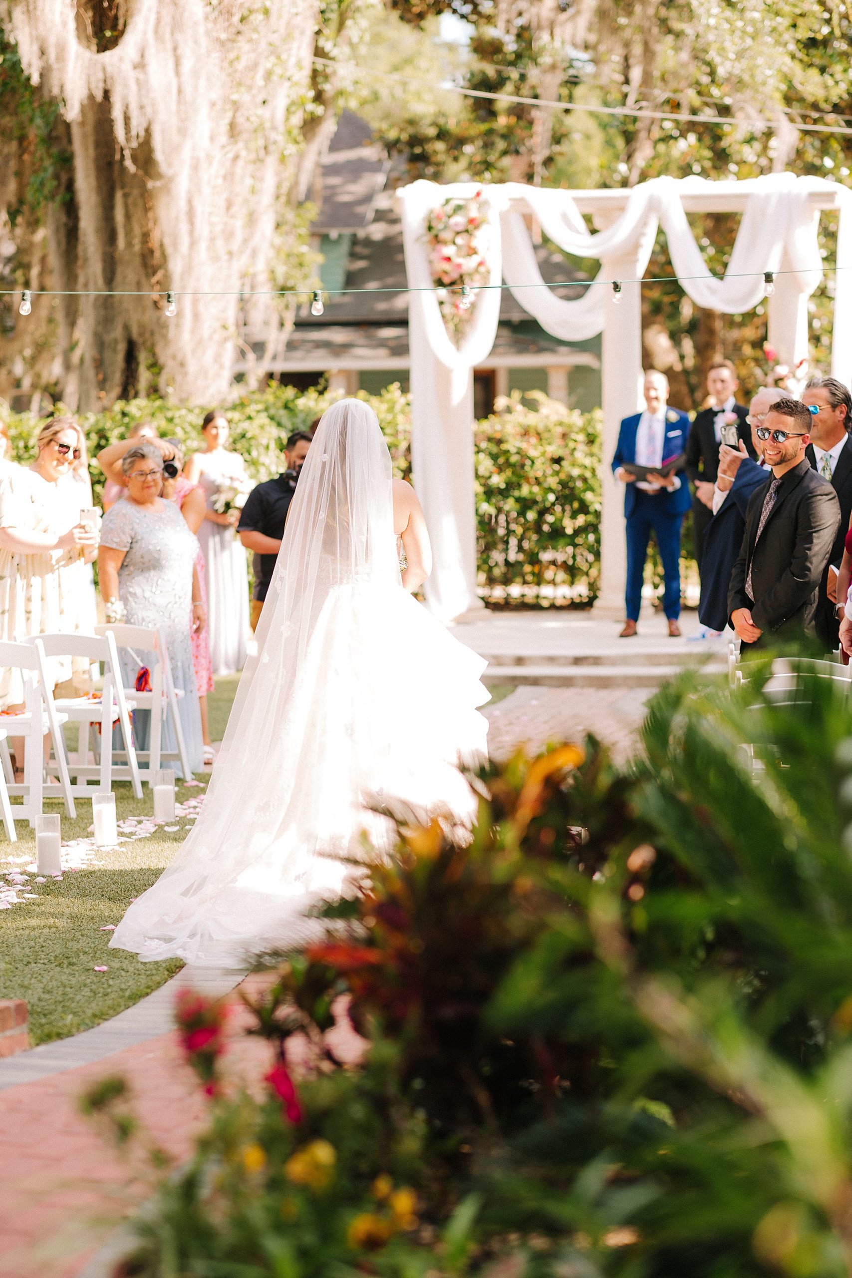 bride walks down aisle for outdoor wedding ceremony in Florida