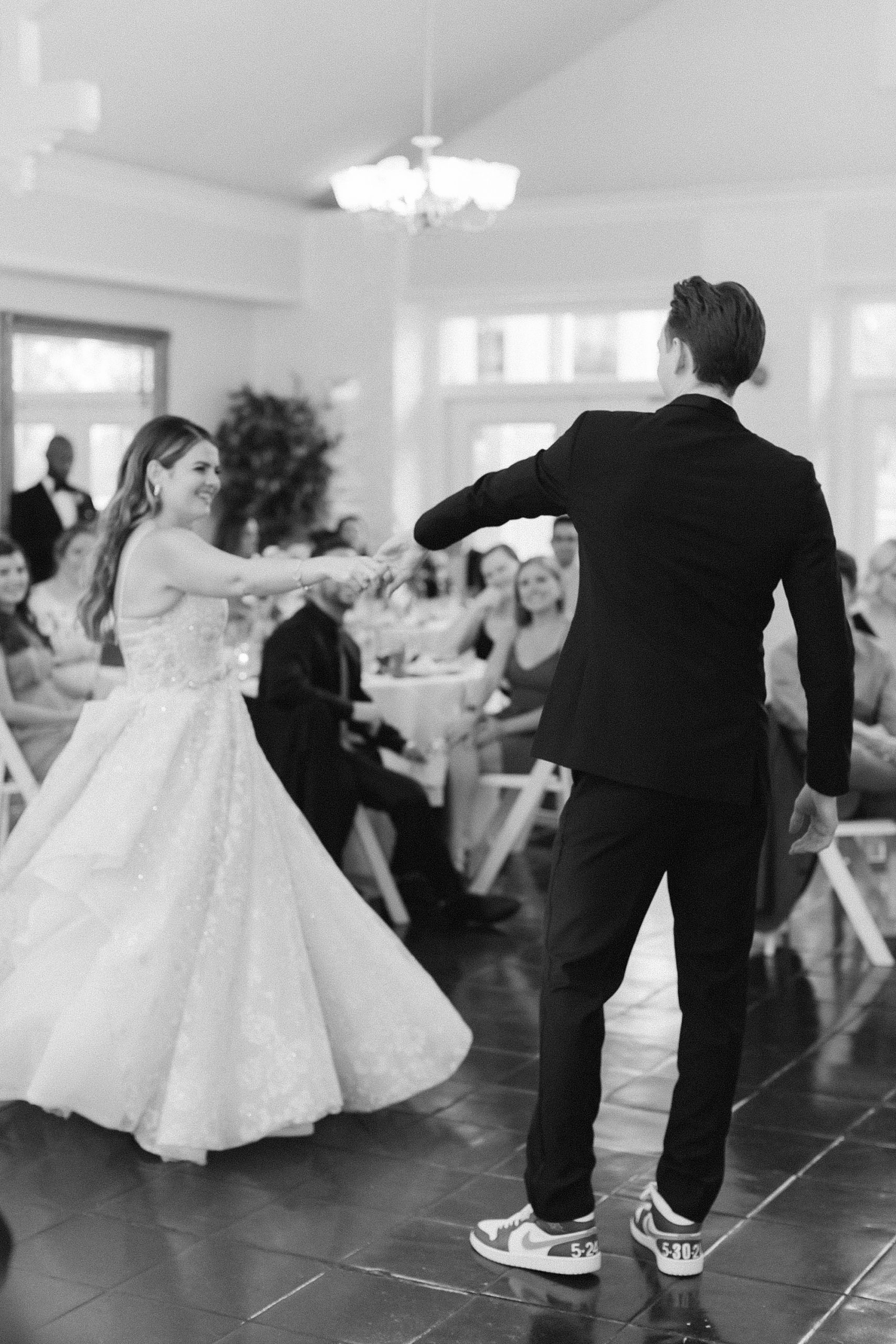 groom twirls bride during first dance at FL wedding reception