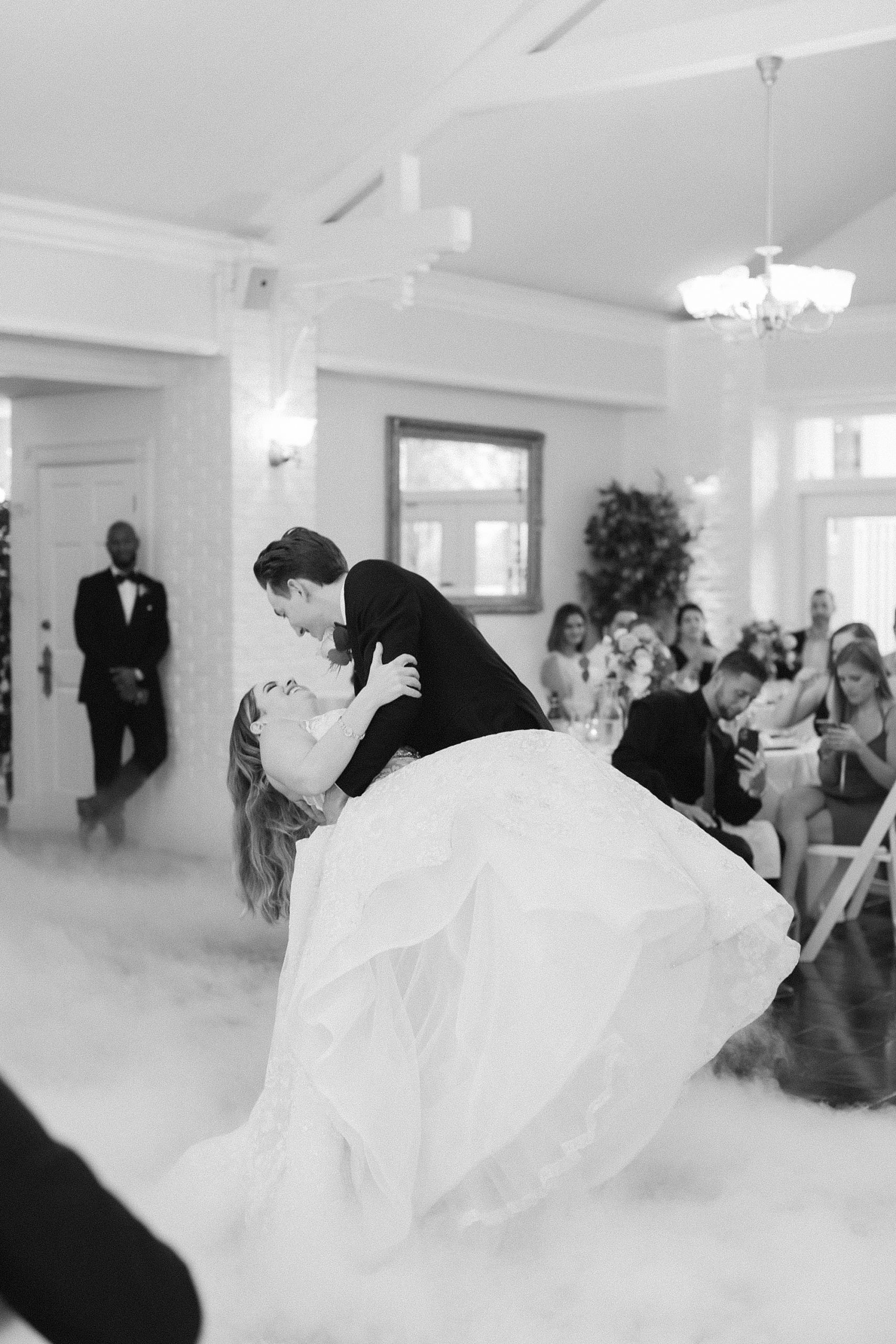 groom dips bride during FL wedding reception