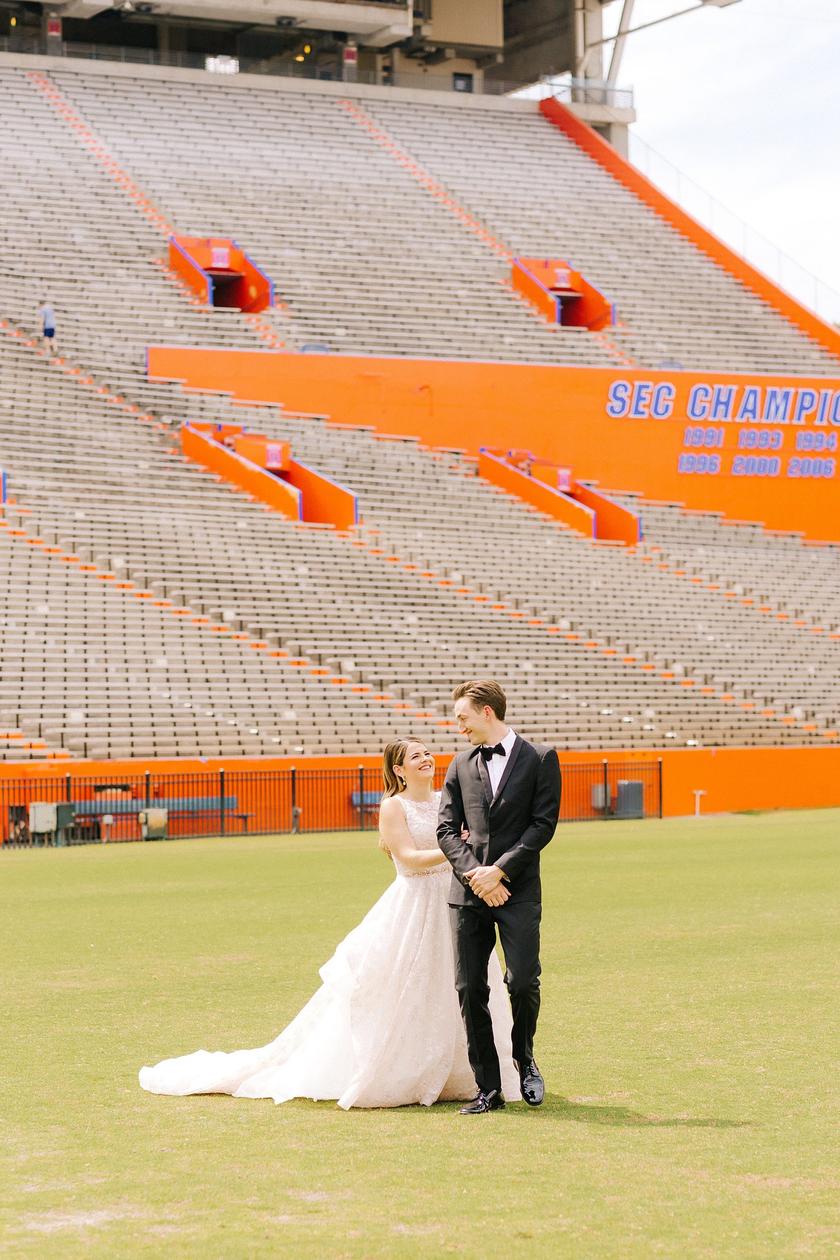 University of Florida wedding portraits of bride and groom on field