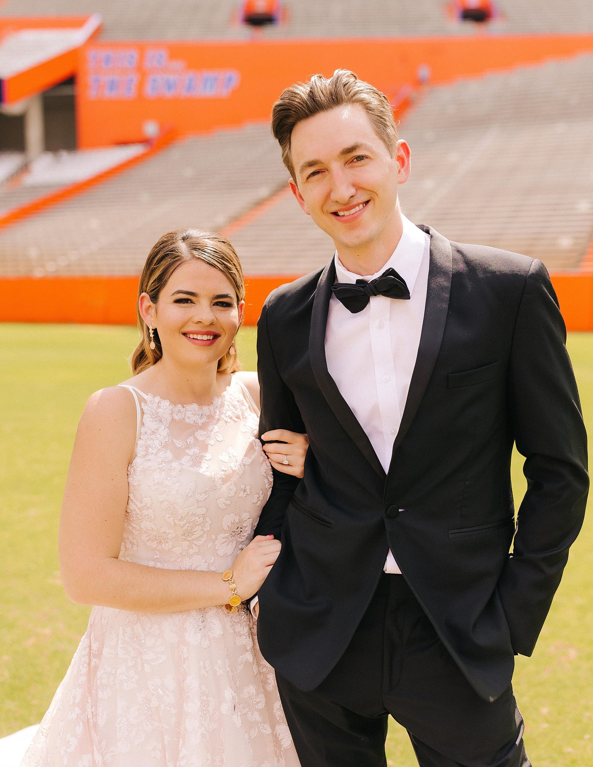bride and groom stand on field at University of Florida