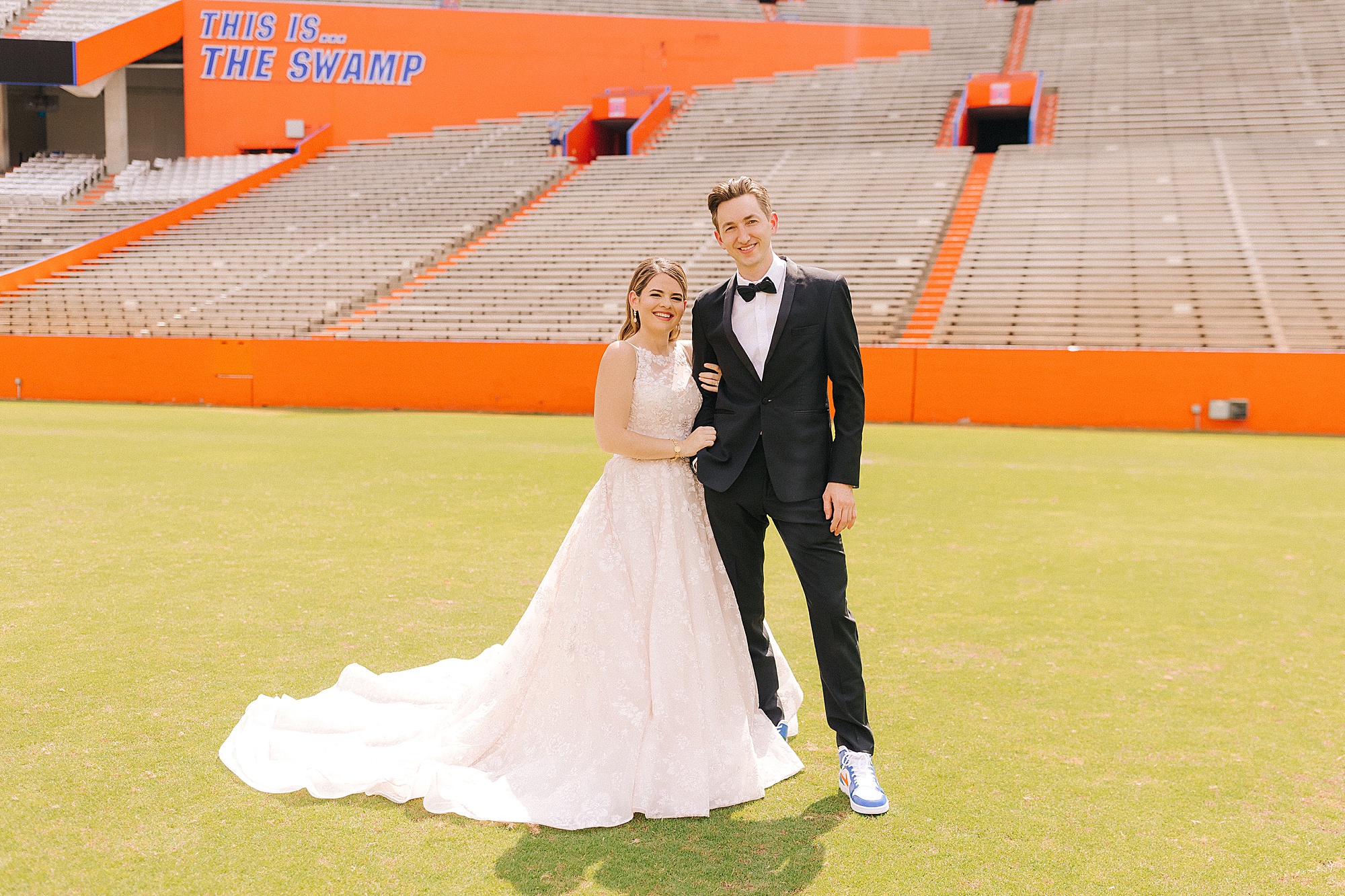 newlyweds pose together on University of Florida football field 