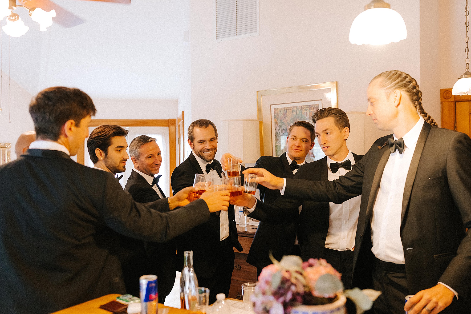 groom and groomsmen toast during wedding prep
