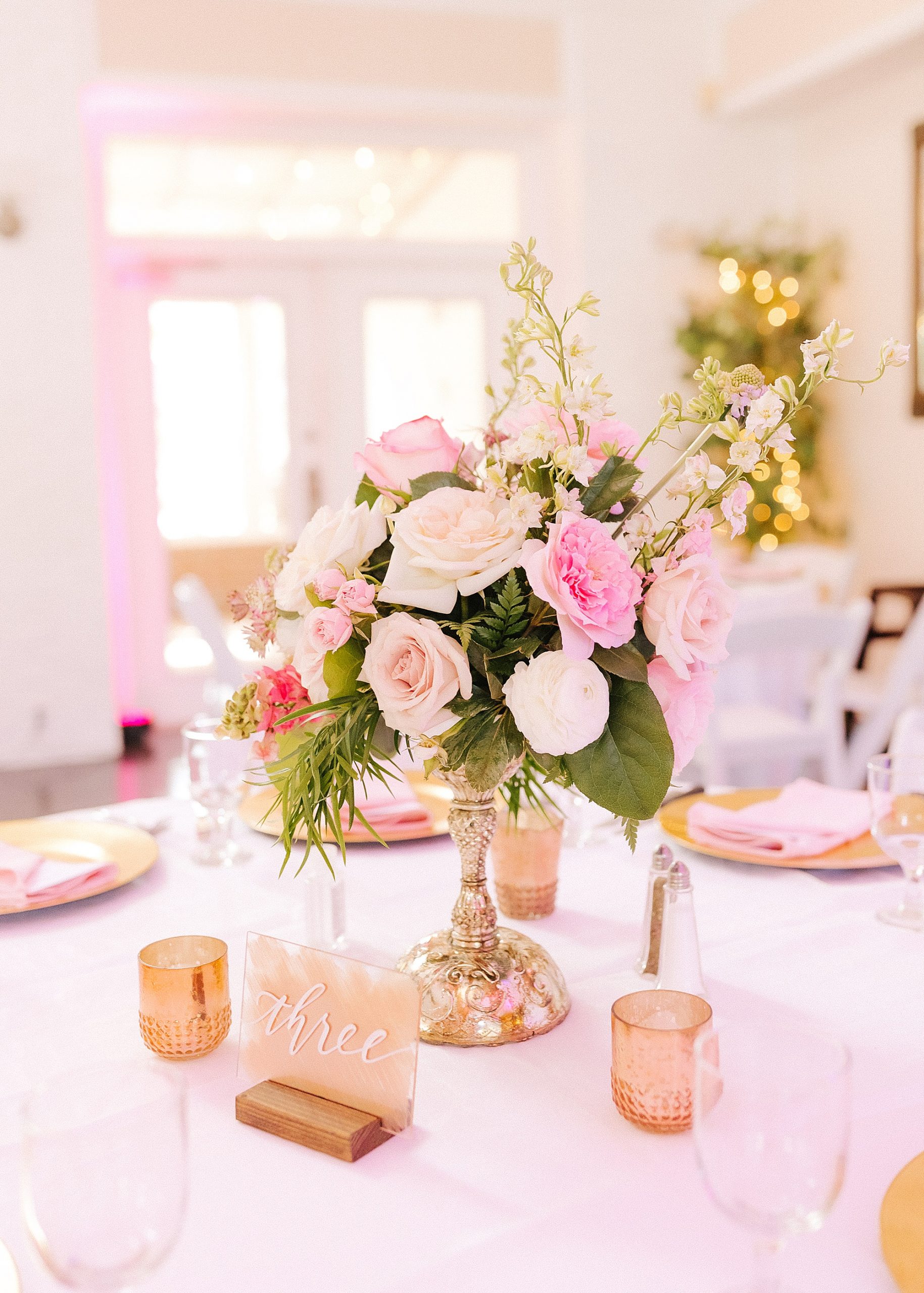 pink and white floral centerpieces during Florida wedding reception