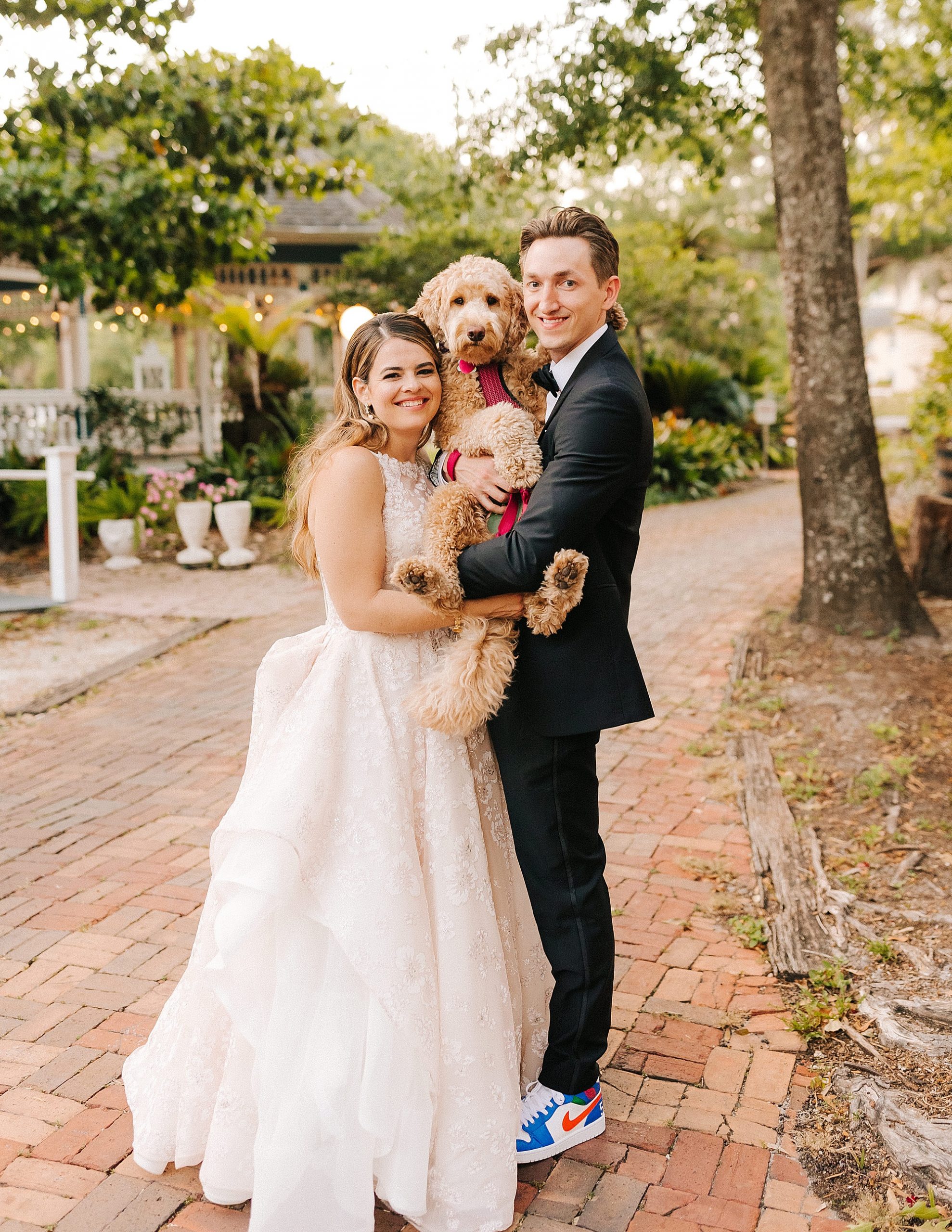couple holds dog during Gainesville FL wedding photos