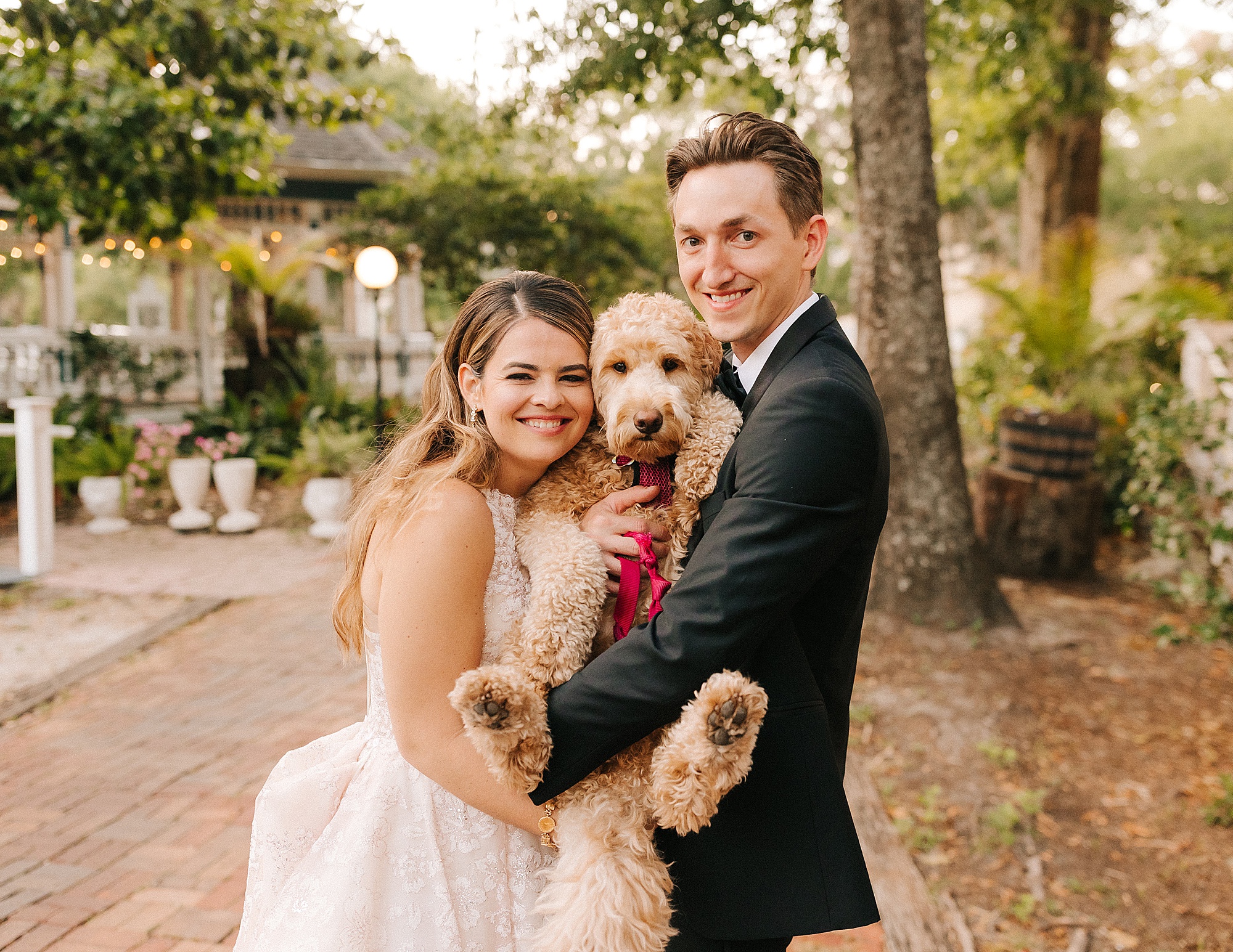 bride and groom hug dog during Gainesville FL wedding photos