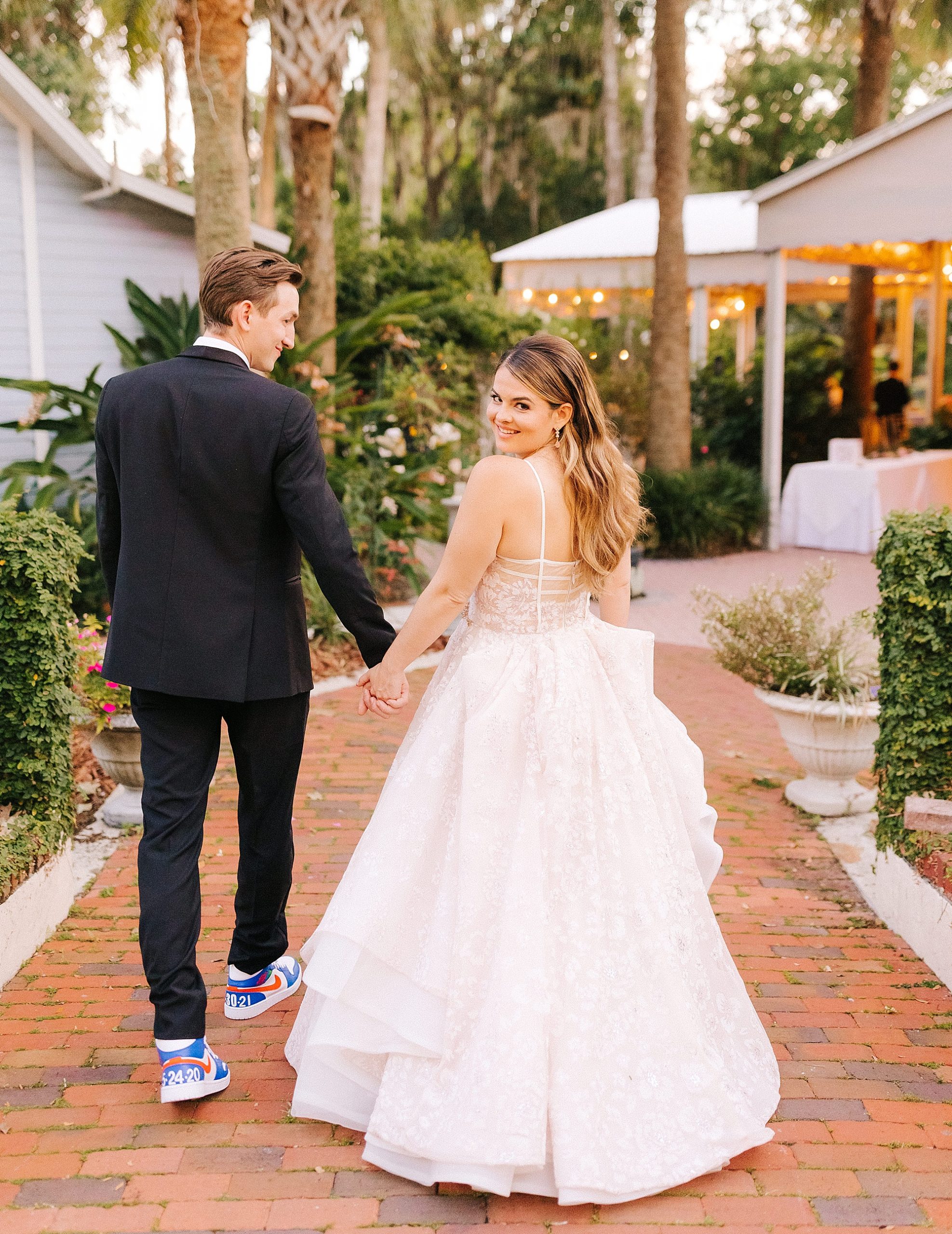 newlyweds walk towards Florida wedding reception