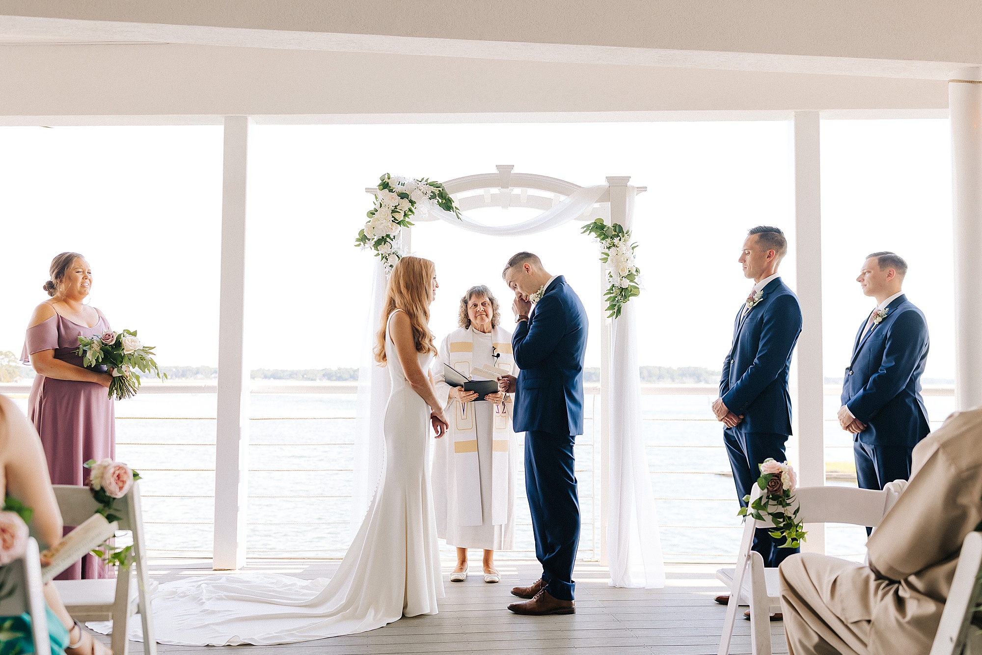 newlyweds exchange vows during waterfront wedding ceremony in Virginia Beach