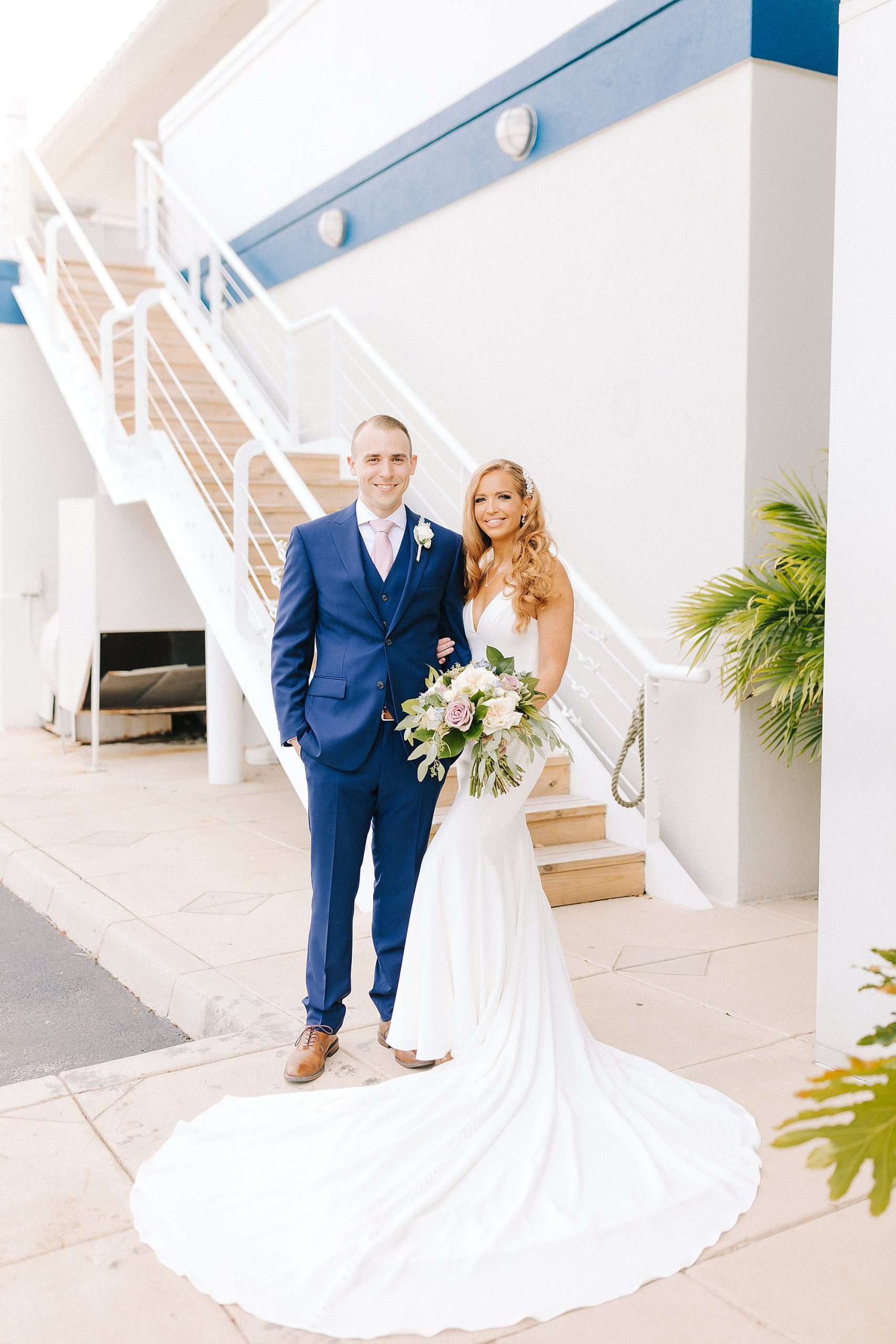 bride and groom pose by staircase in Lesner Inn