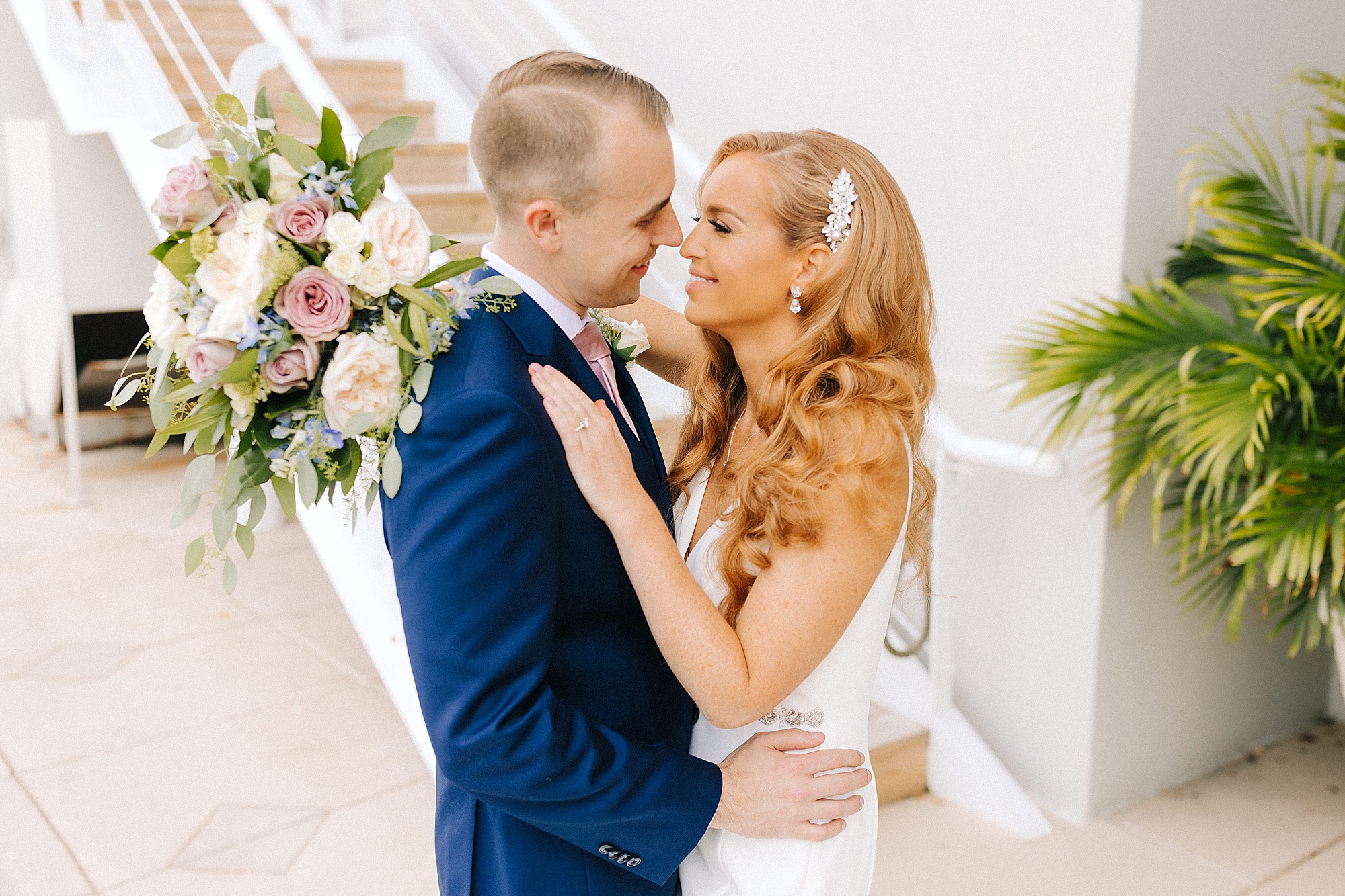 bride and groom stand nose to nose inside Lesner Inn
