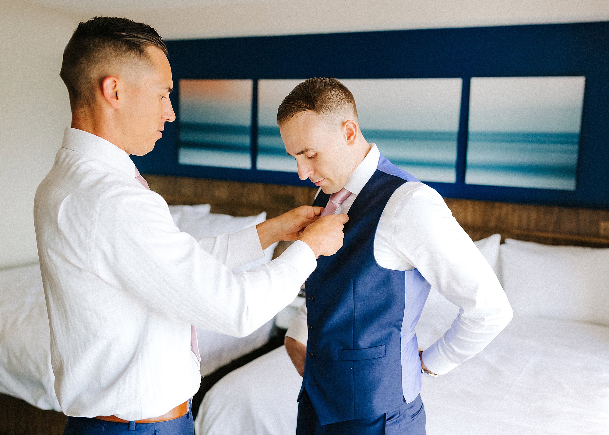 groomsman helps groom with tie before Lesner Inn wedding