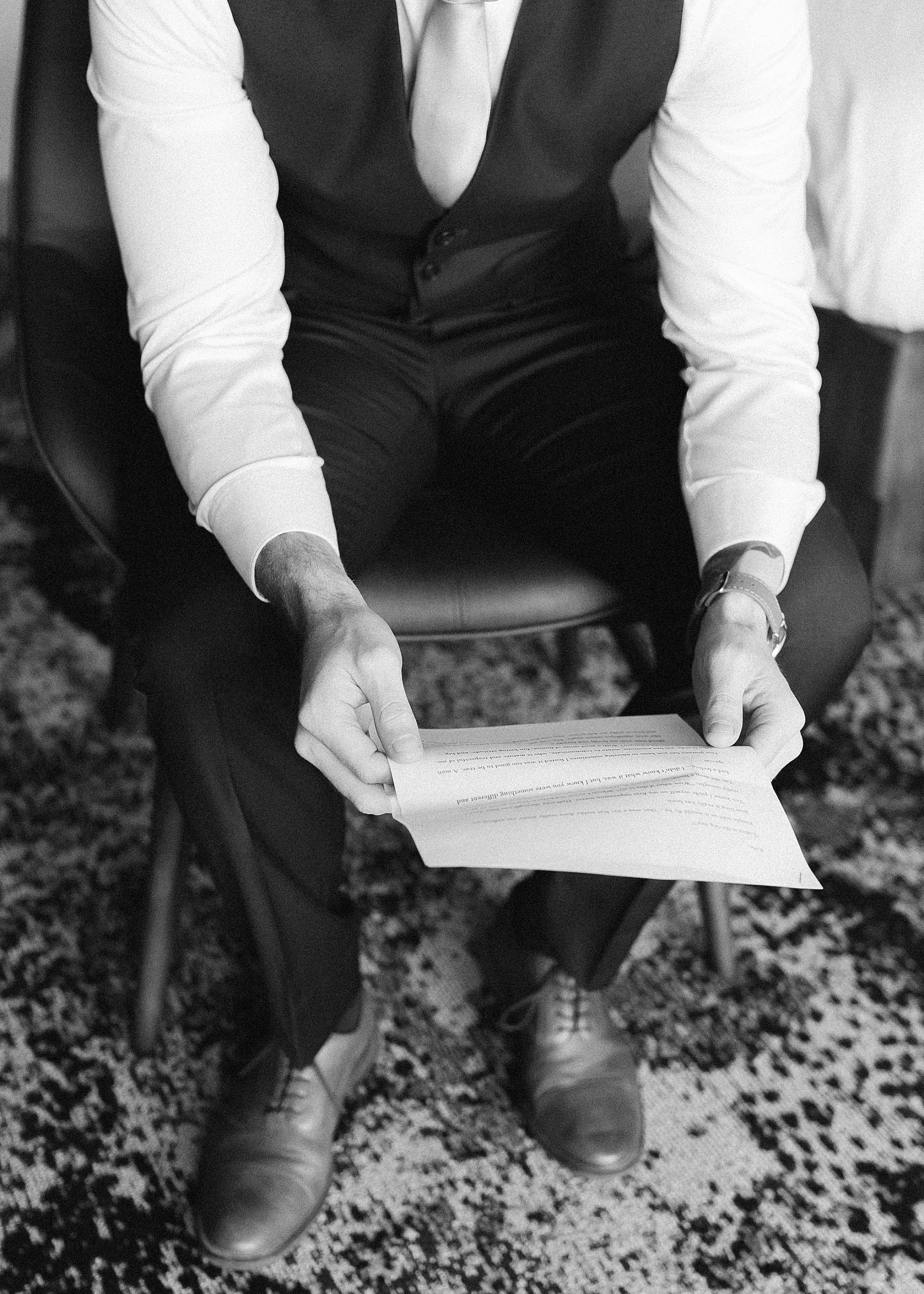 groom reads letter from bride on wedding day