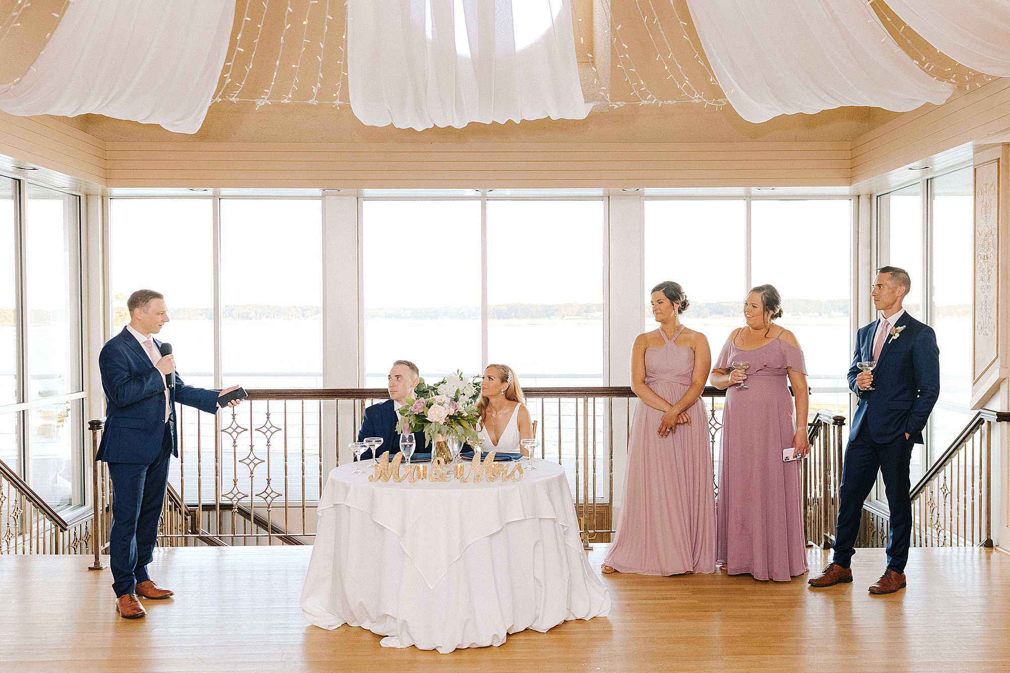 newlyweds listen to toasts during Virginia Beach wedding reception