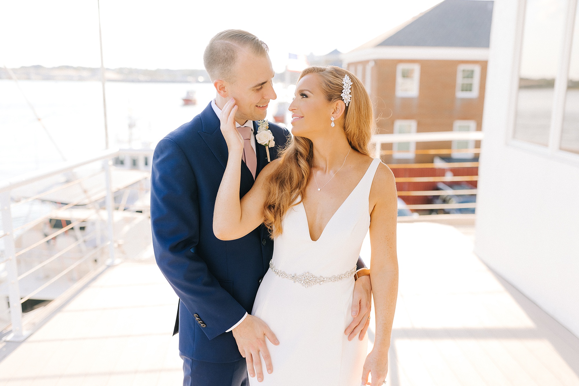 bride reaches behind her to touch groom's chin during VA wedding photos