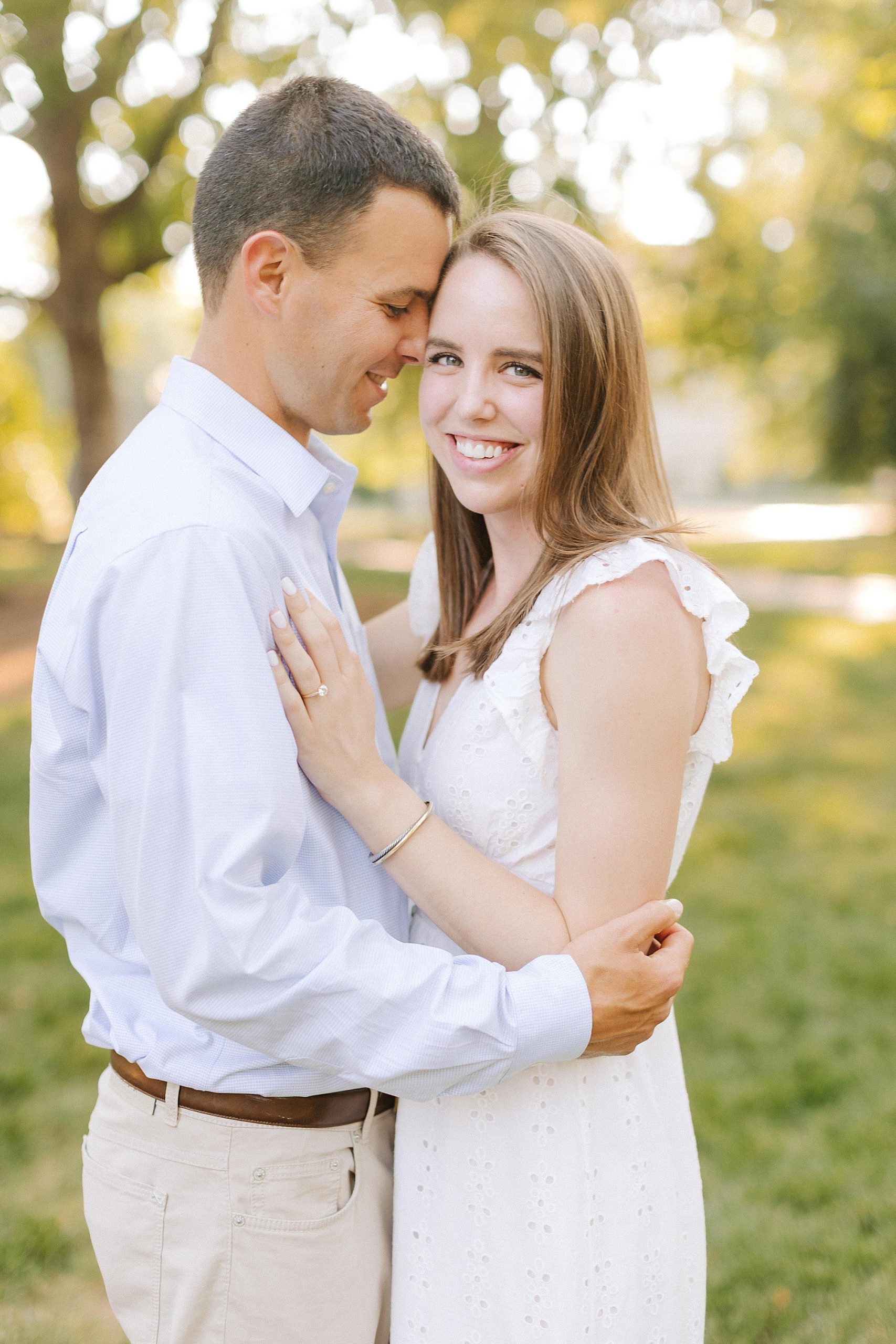 groom nuzzles bride's head during UNC Chapel Hill engagement session