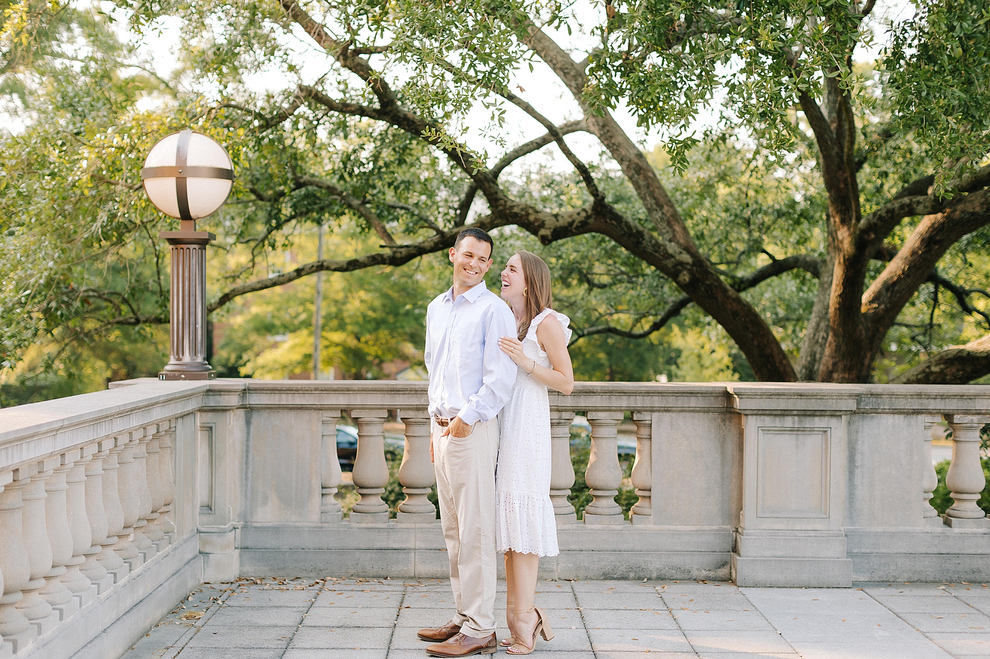 engaged couple stands on patio at UNC Chapel Hill