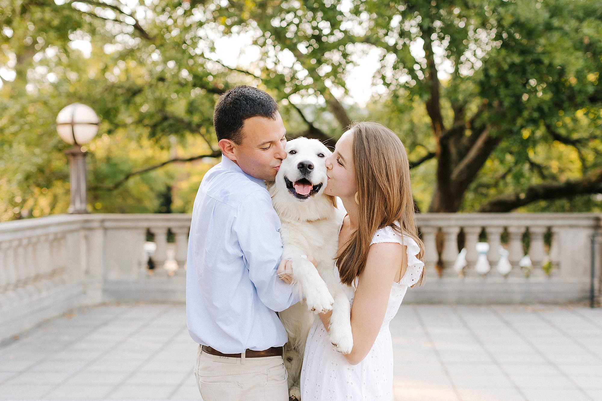 engaged couple kiss dog during UNC Chapel Hill engagement photos