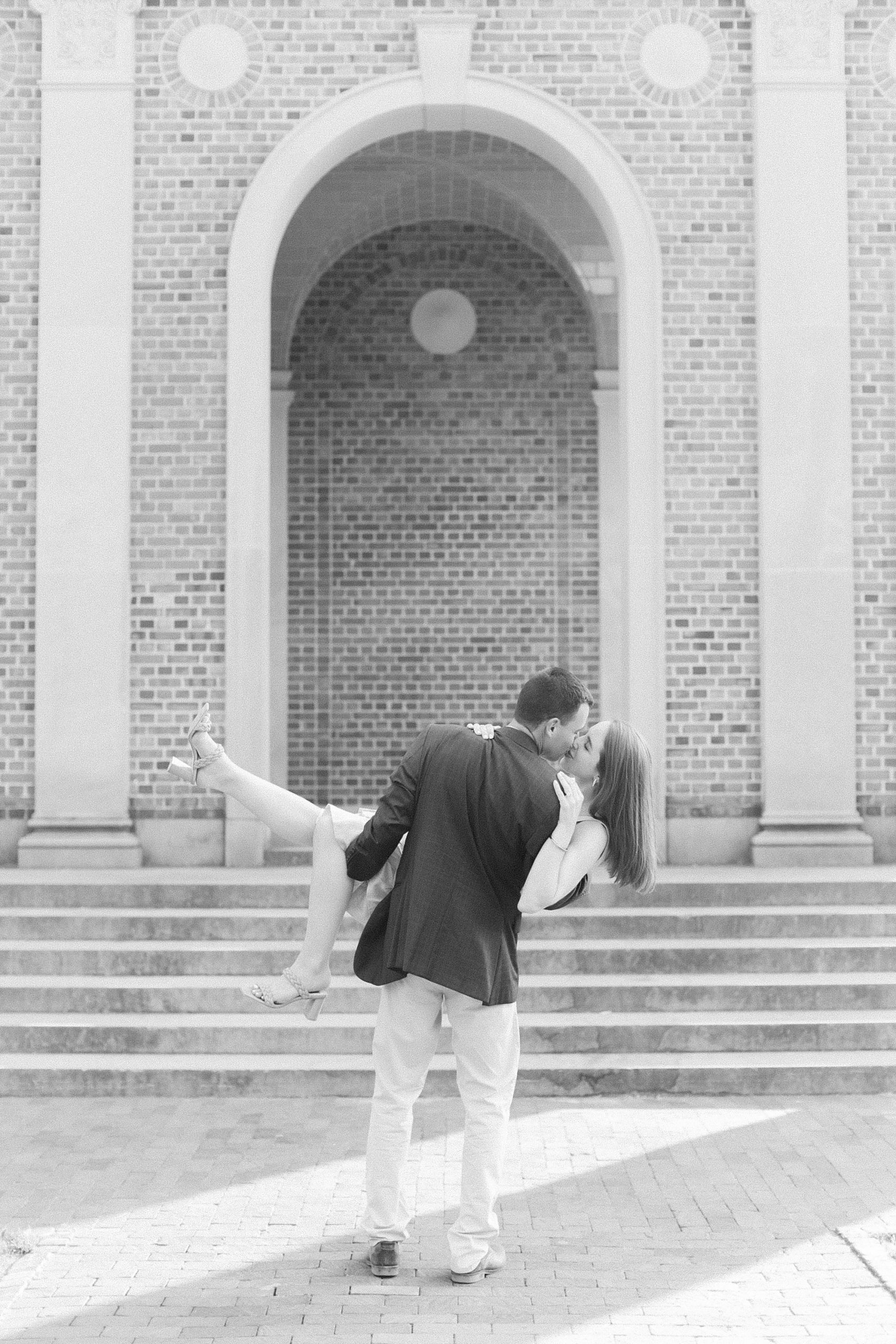 groom lifts bride during UNC Chapel Hill engagement session