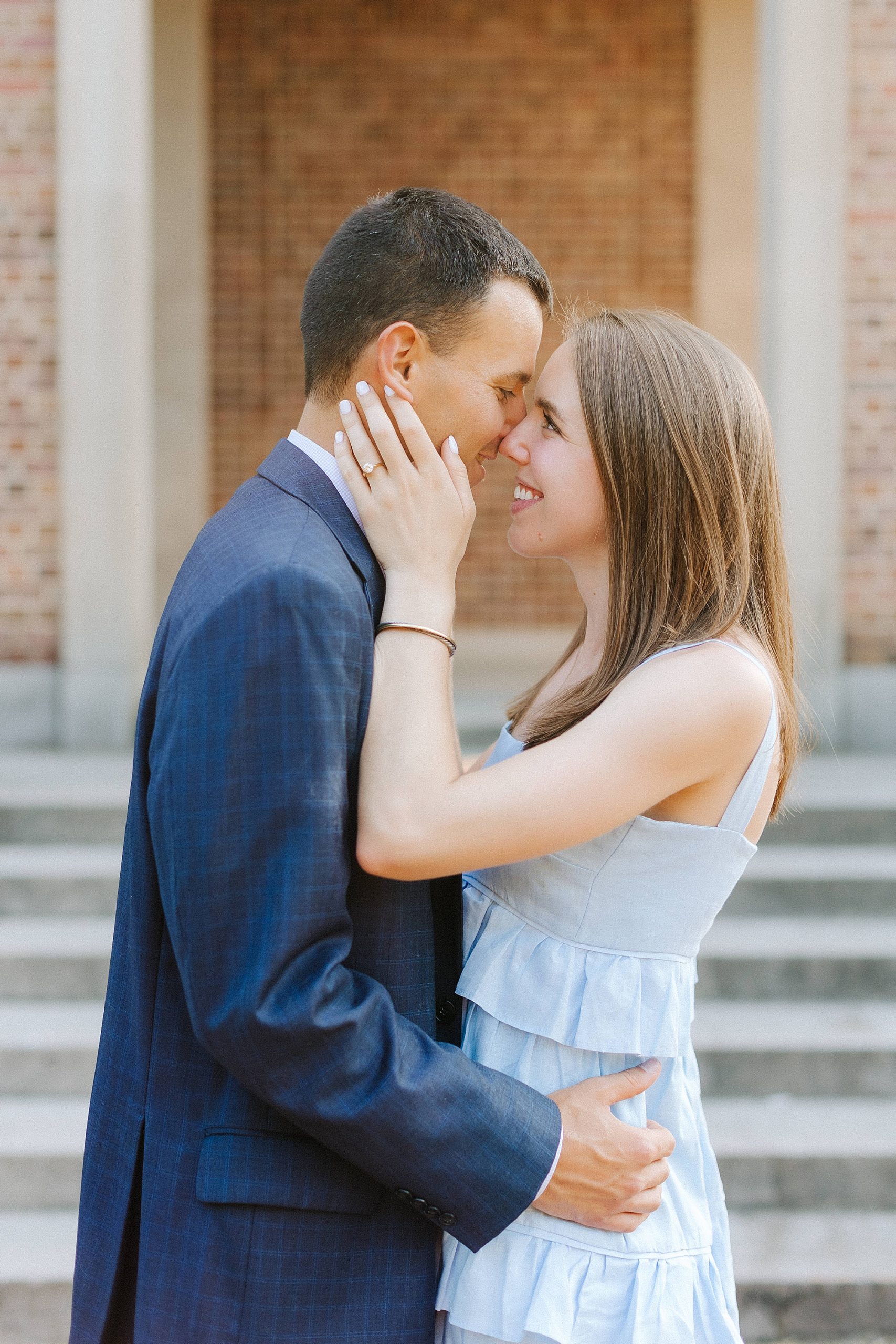 bride and groom stand nose to nose during engagement photos in NC