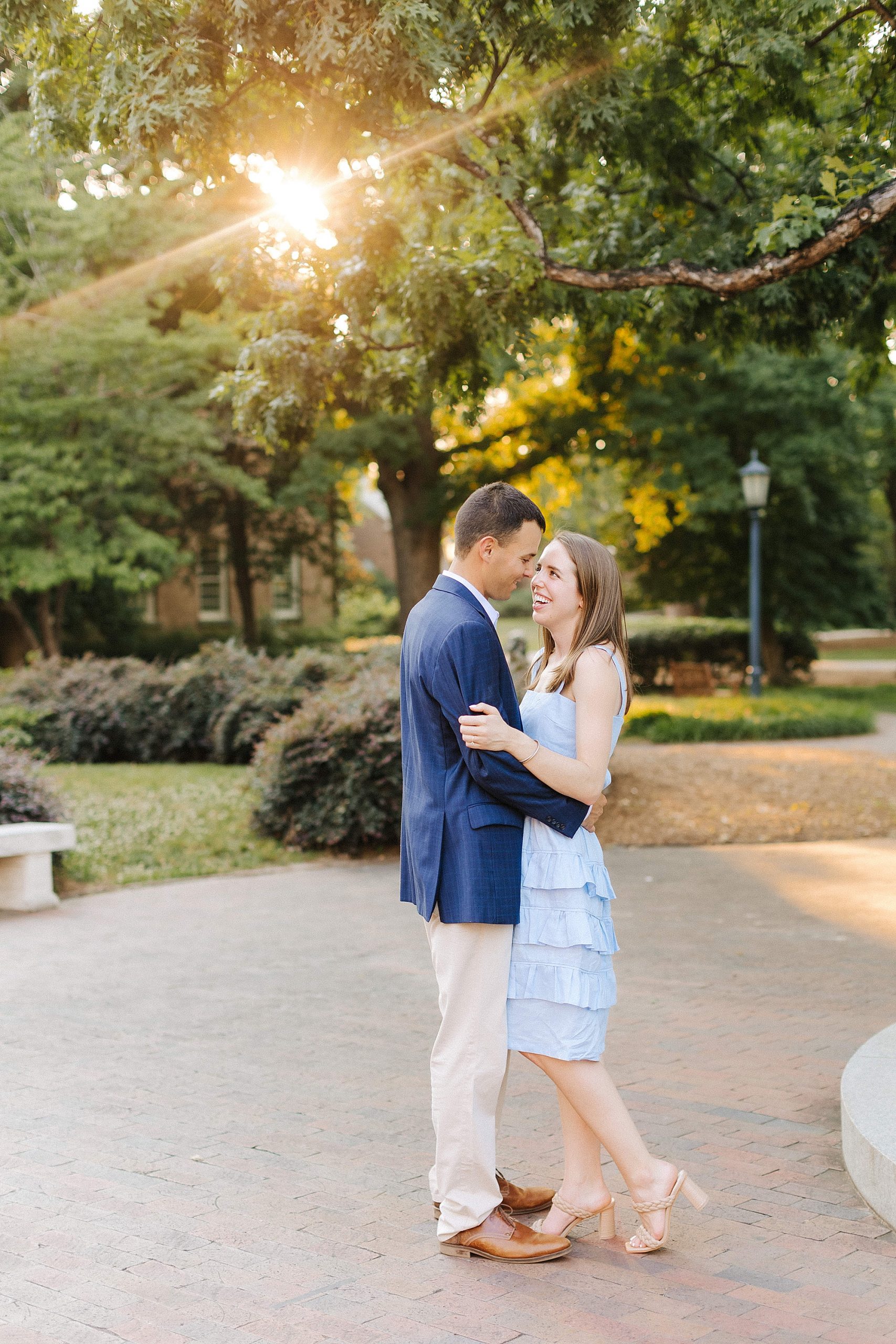 bride and groom hug during UNC Chapel Hill engagement session