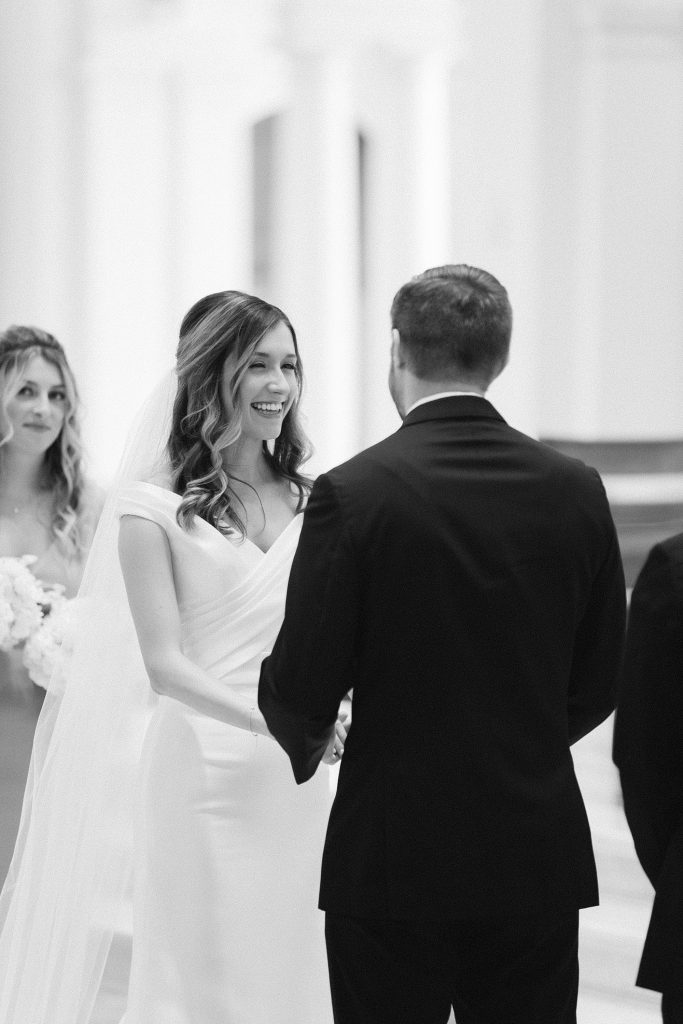 bride smiles at groom during traditional church wedding in Raleigh NC 