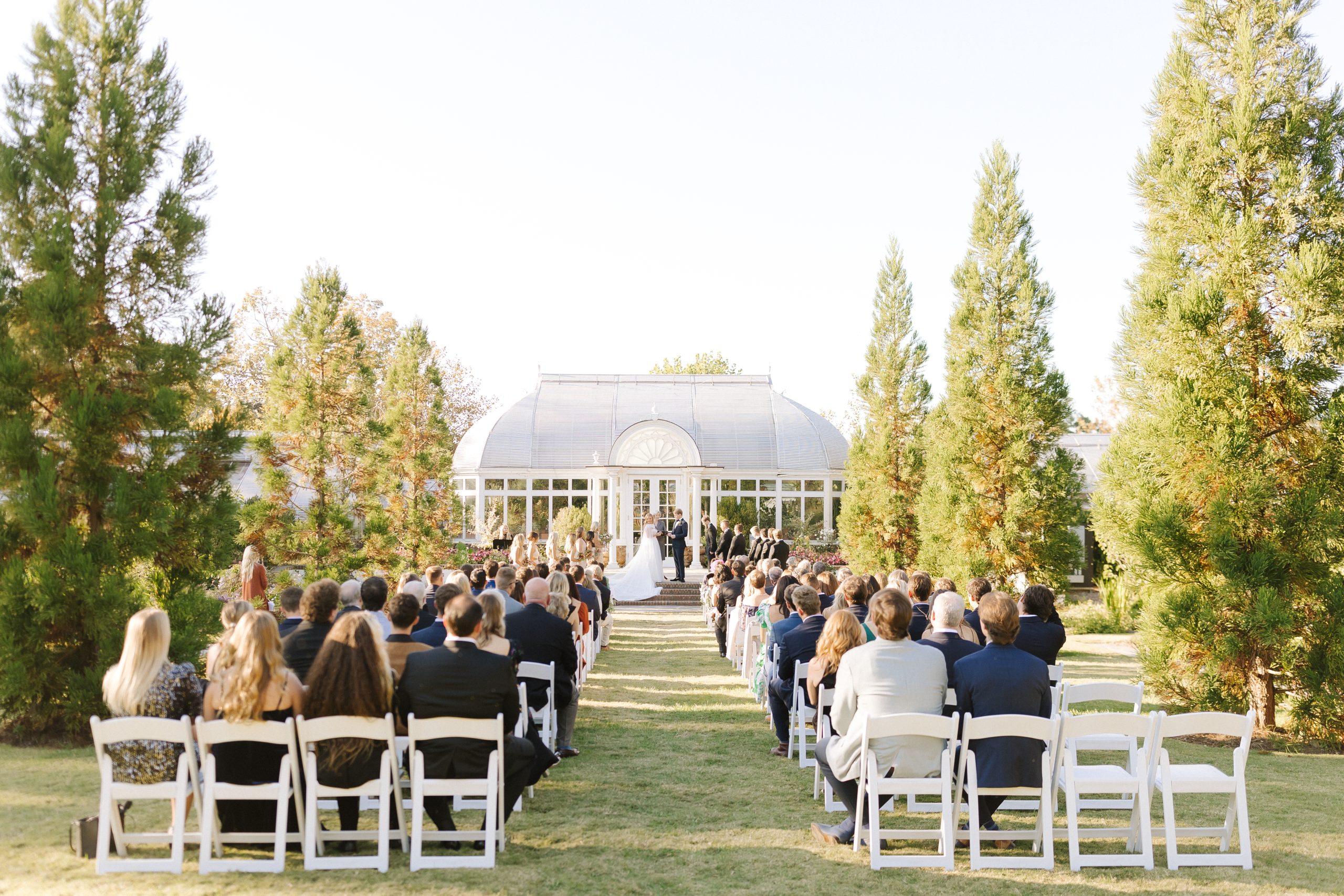 An early Fall Ceremony takes place in front of he greenhouse at Reynolda Gardens in Winston-Salem, NC