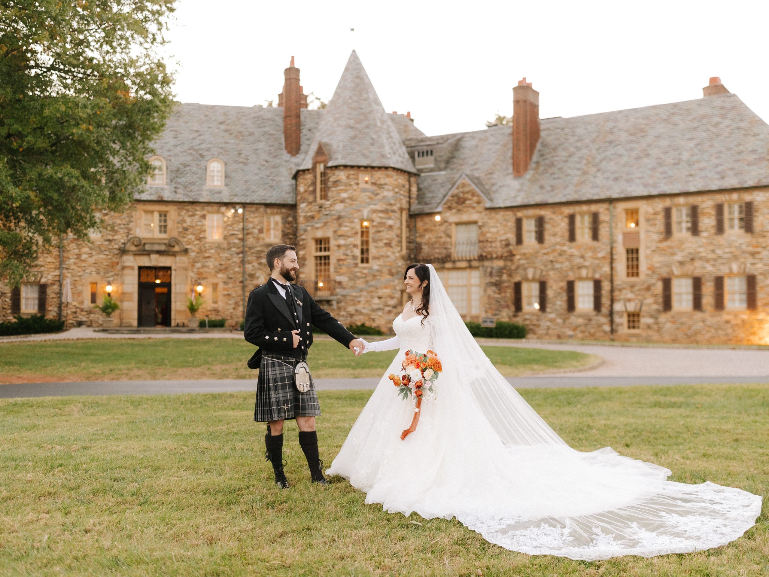A couple stands in their scottish attire in front of The Graylyn Estate on their wedding day in Winston-Salem.