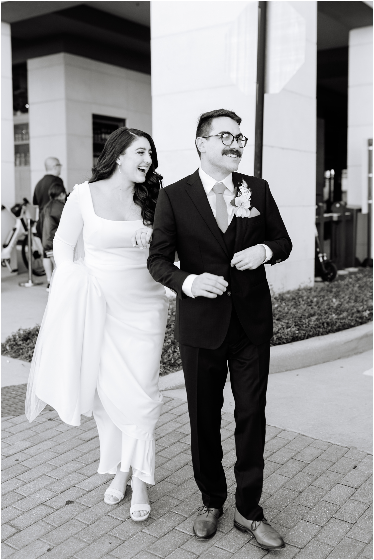black and white candid image of a couple walking together on their wedding day in South Tampa, FL