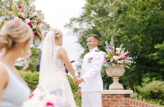 A groom stands in his Naval jacket smiling at his wife to be in this Galax, Virginia Wedding