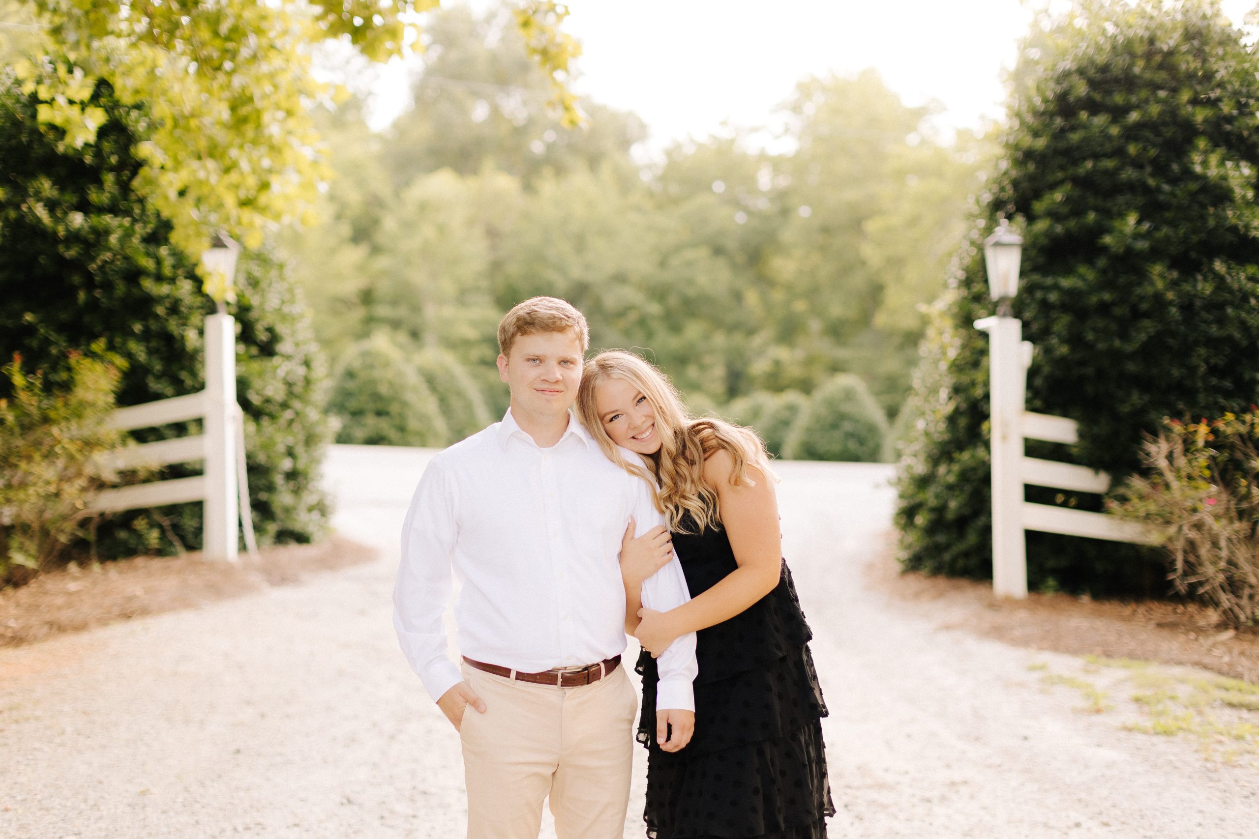 A couple hugs at Vesuvius Vinyards in Iron Station, NC for their engagement photos